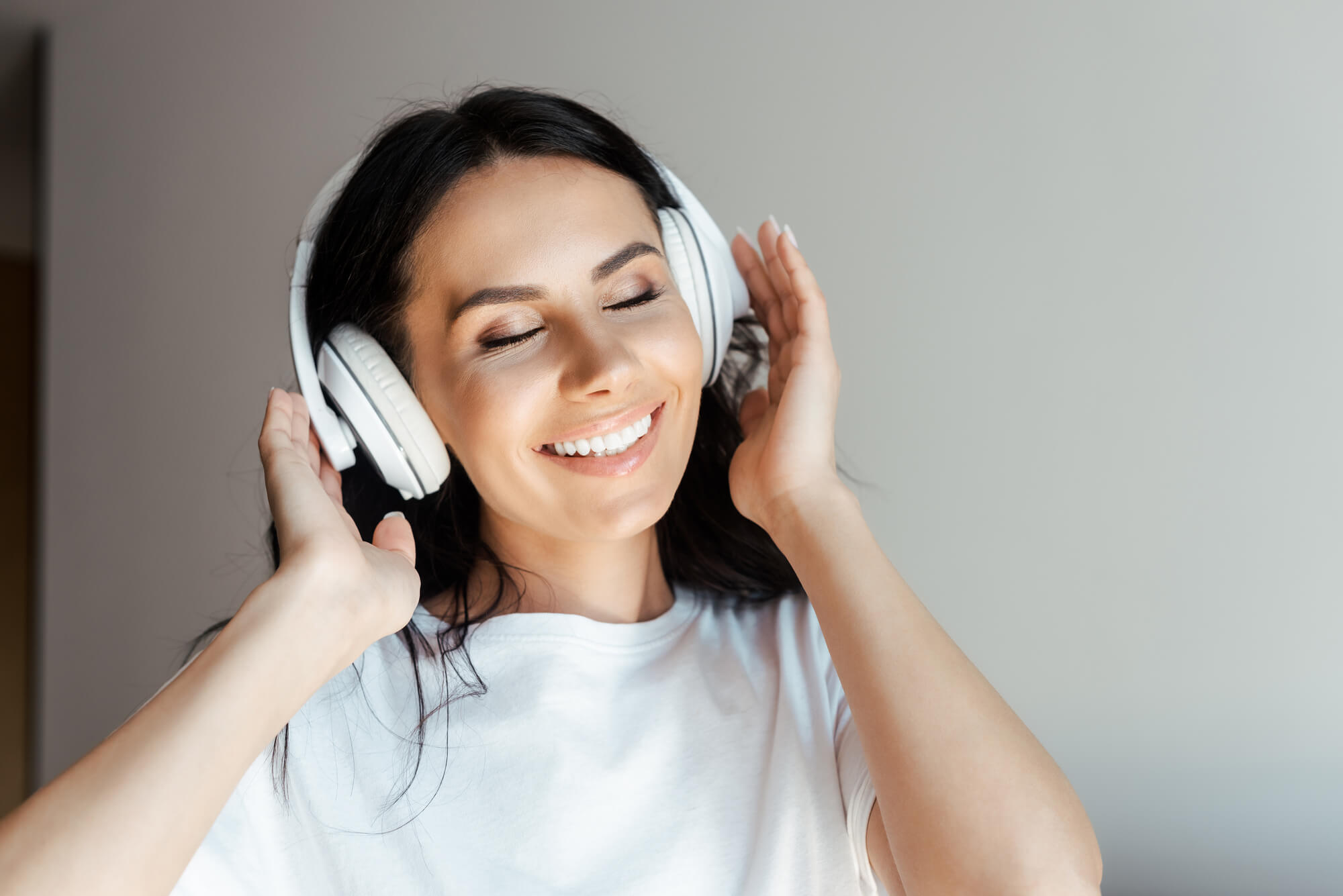 woman happily listening with her headphones