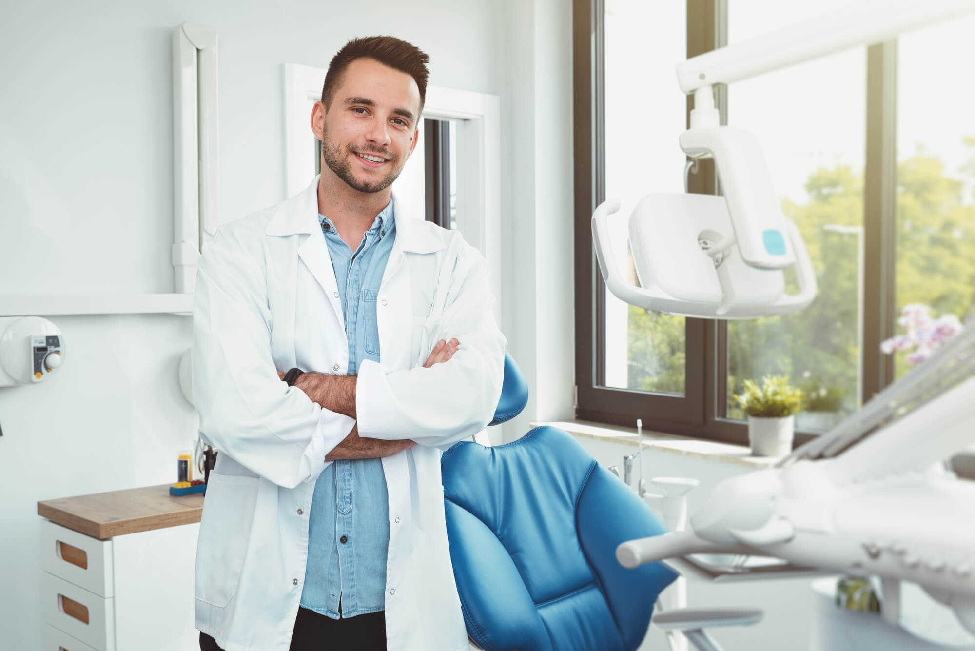 confident dentist posing in his clinic