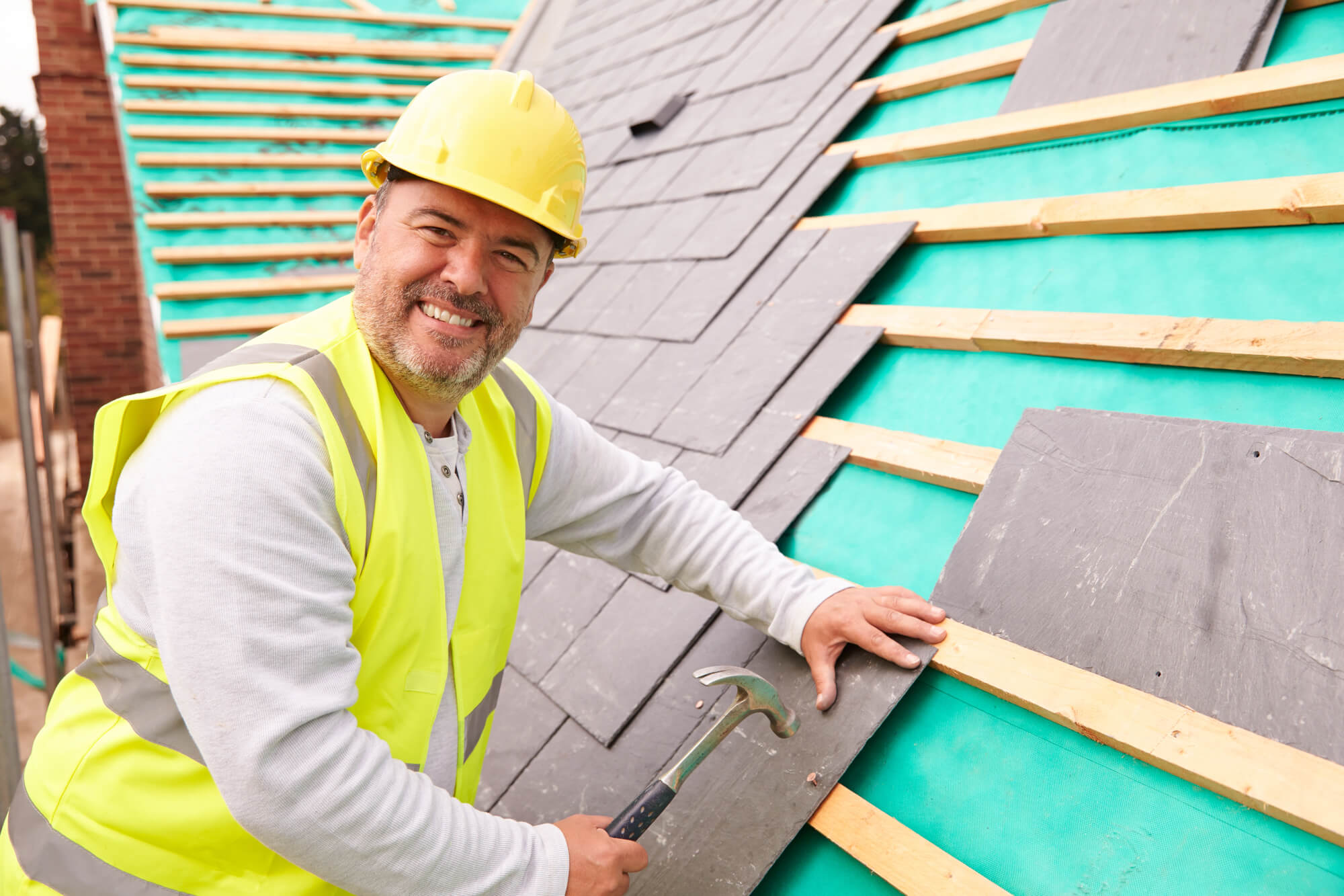 roofer smiling while doing his job