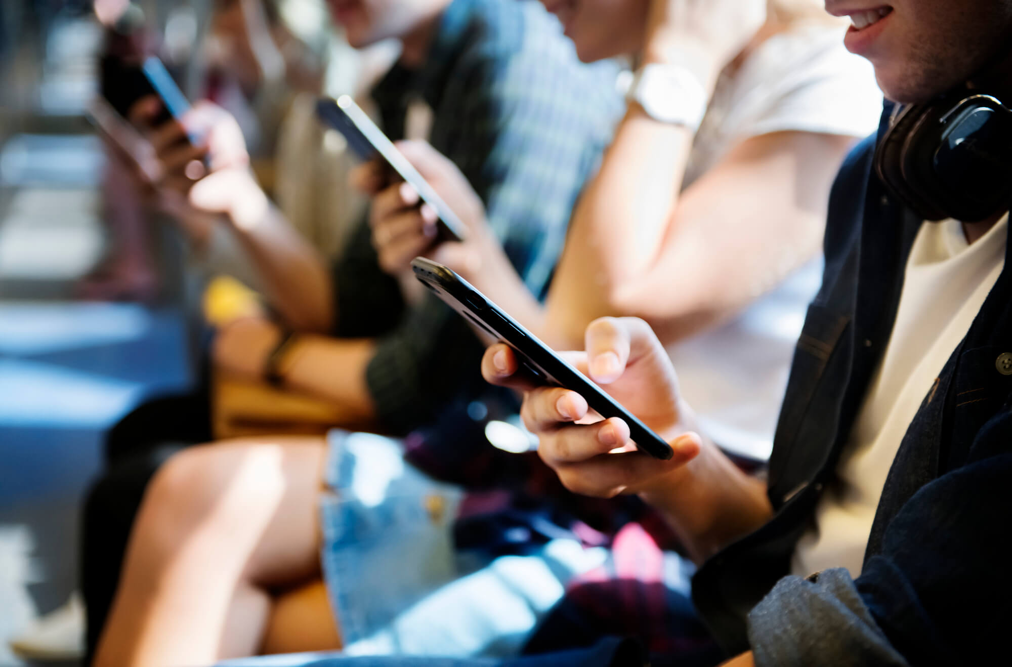 people on a subway concentrating on their smartphones