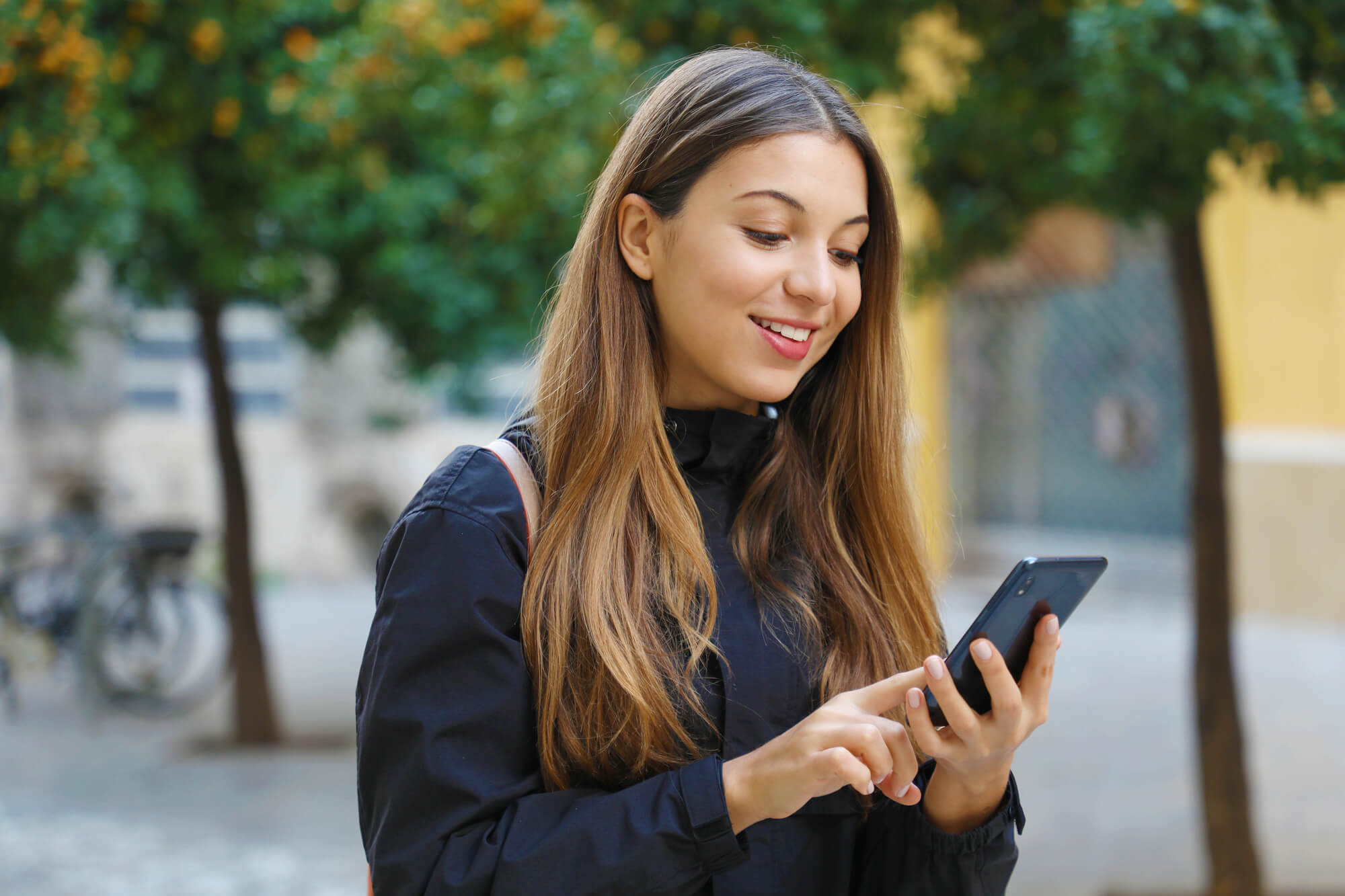 woman looking at her phone with enthusiasm