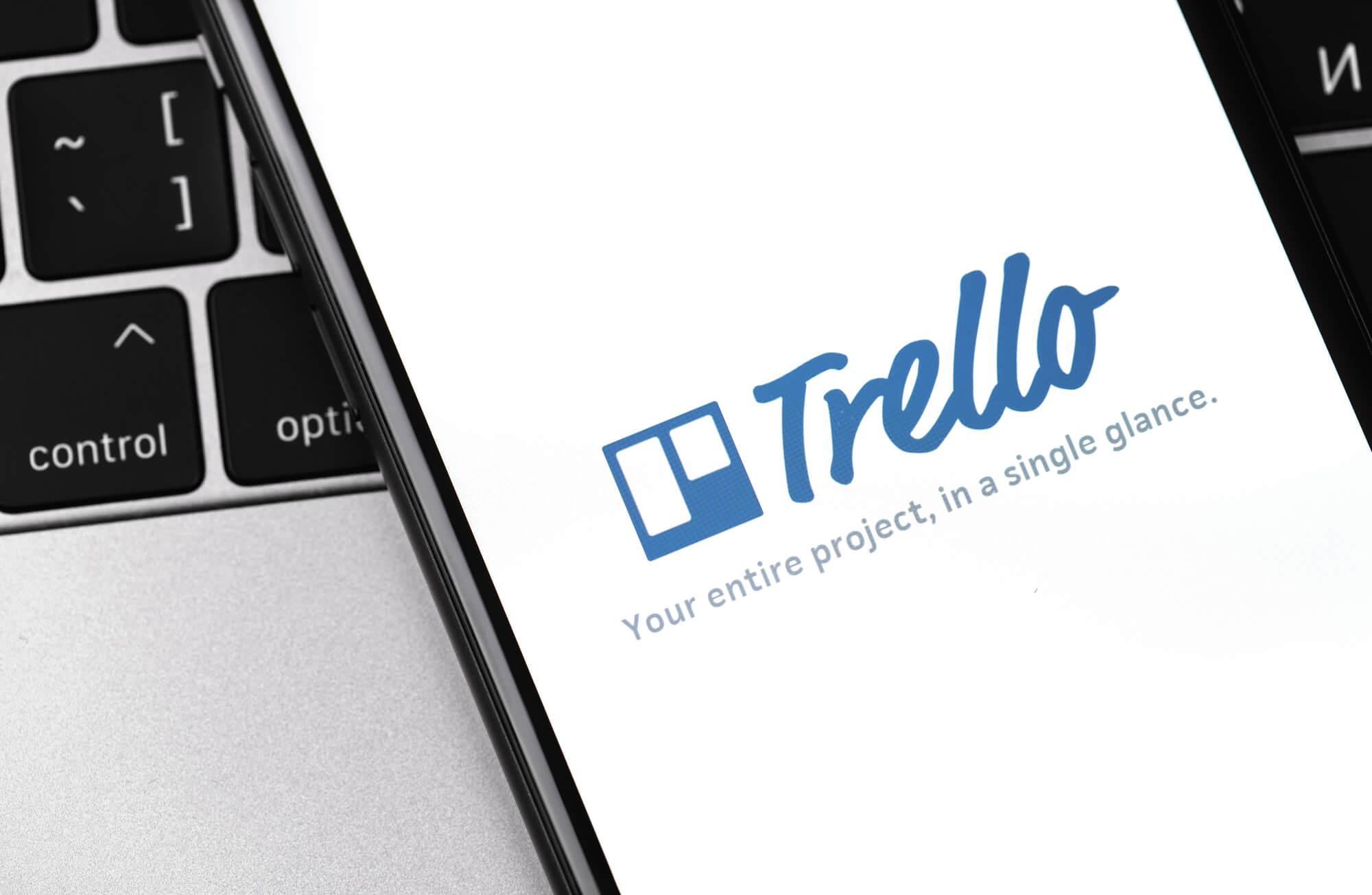 phone showing trello logo and slogan