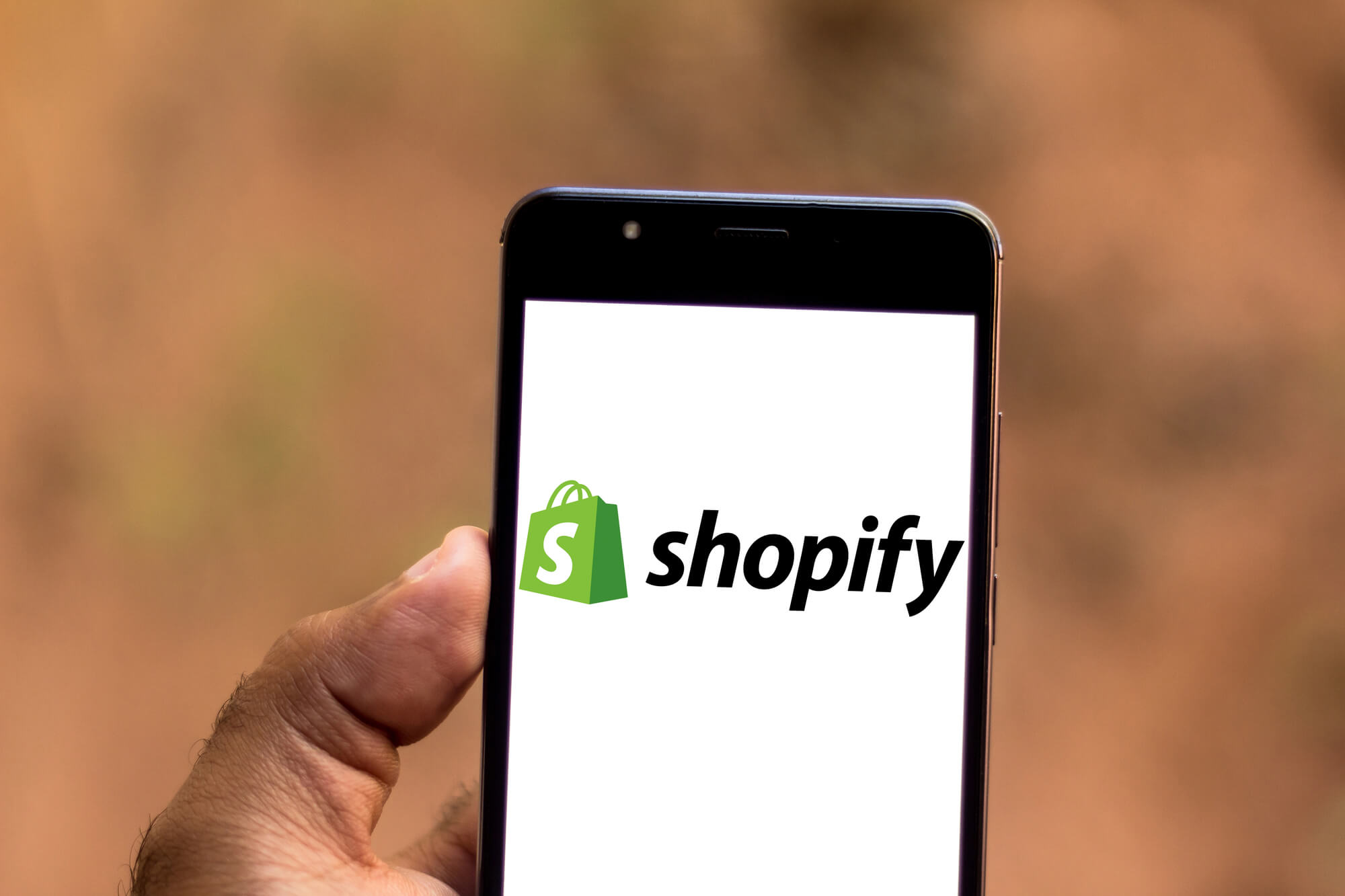 person using shopify on phone