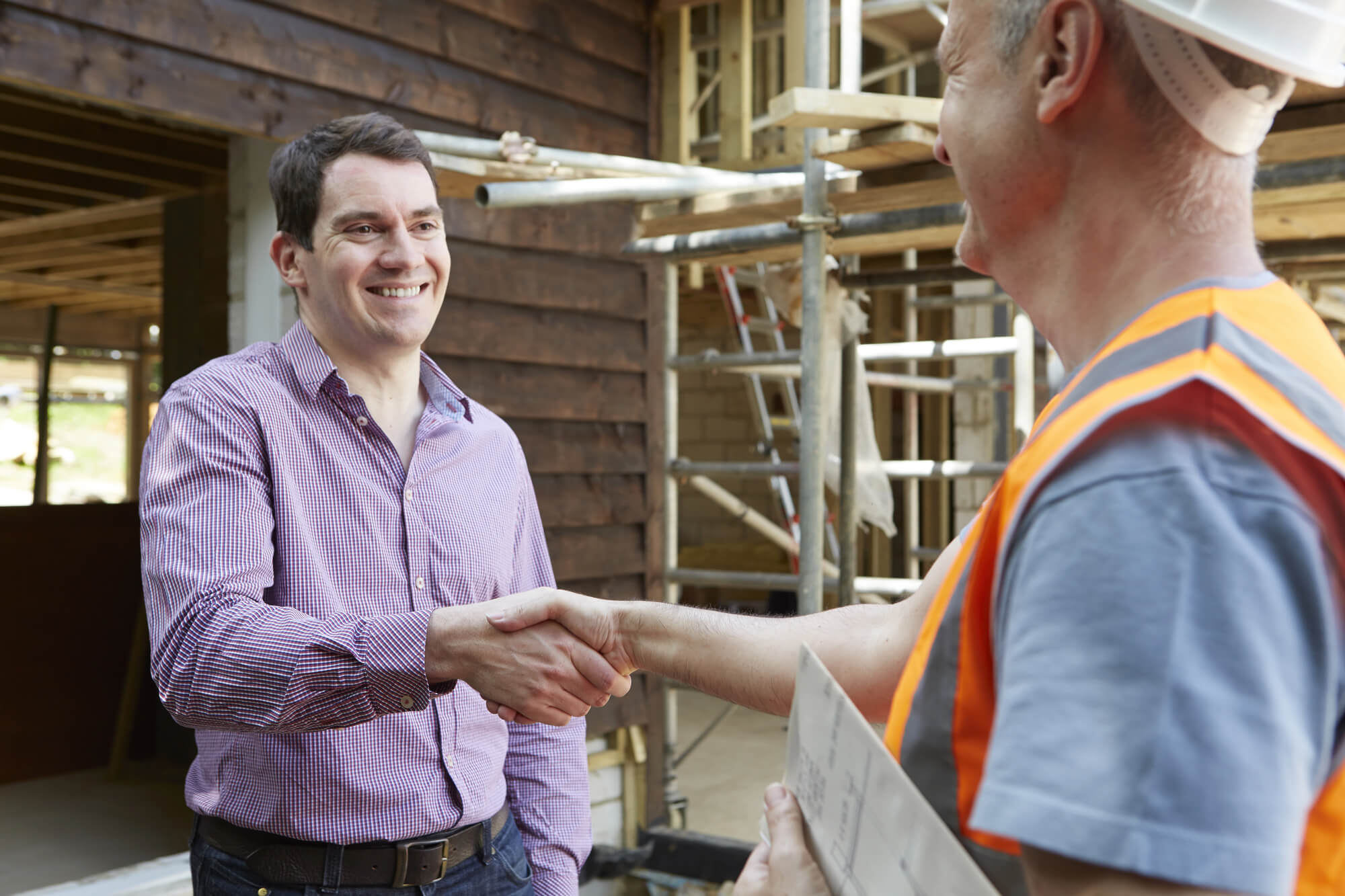 contractor shaking hands with client