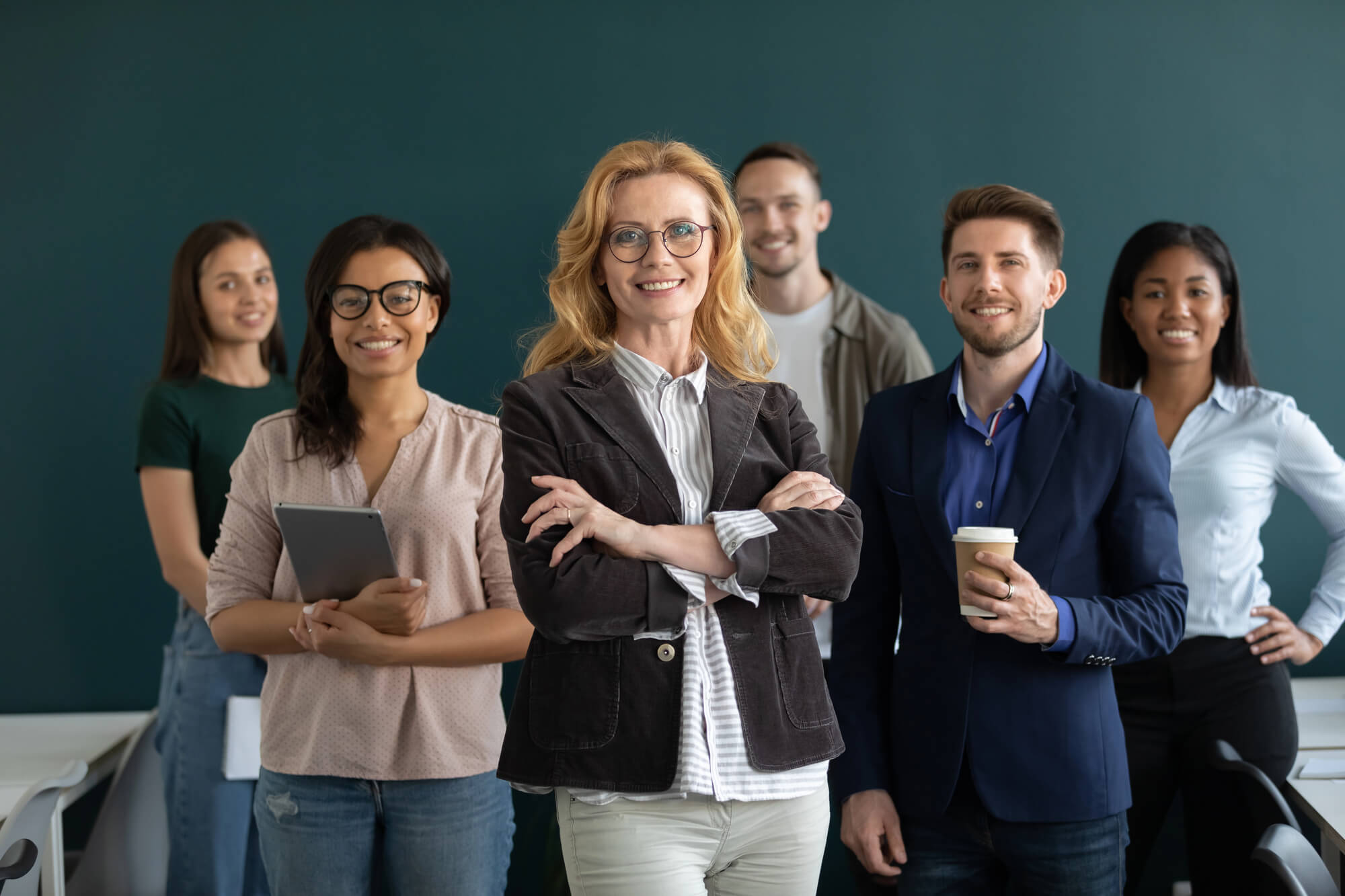 female business owner posing confidently with her team