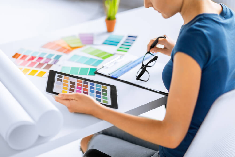 graphic designer of social media marketing company browsing colors on digital tablet
