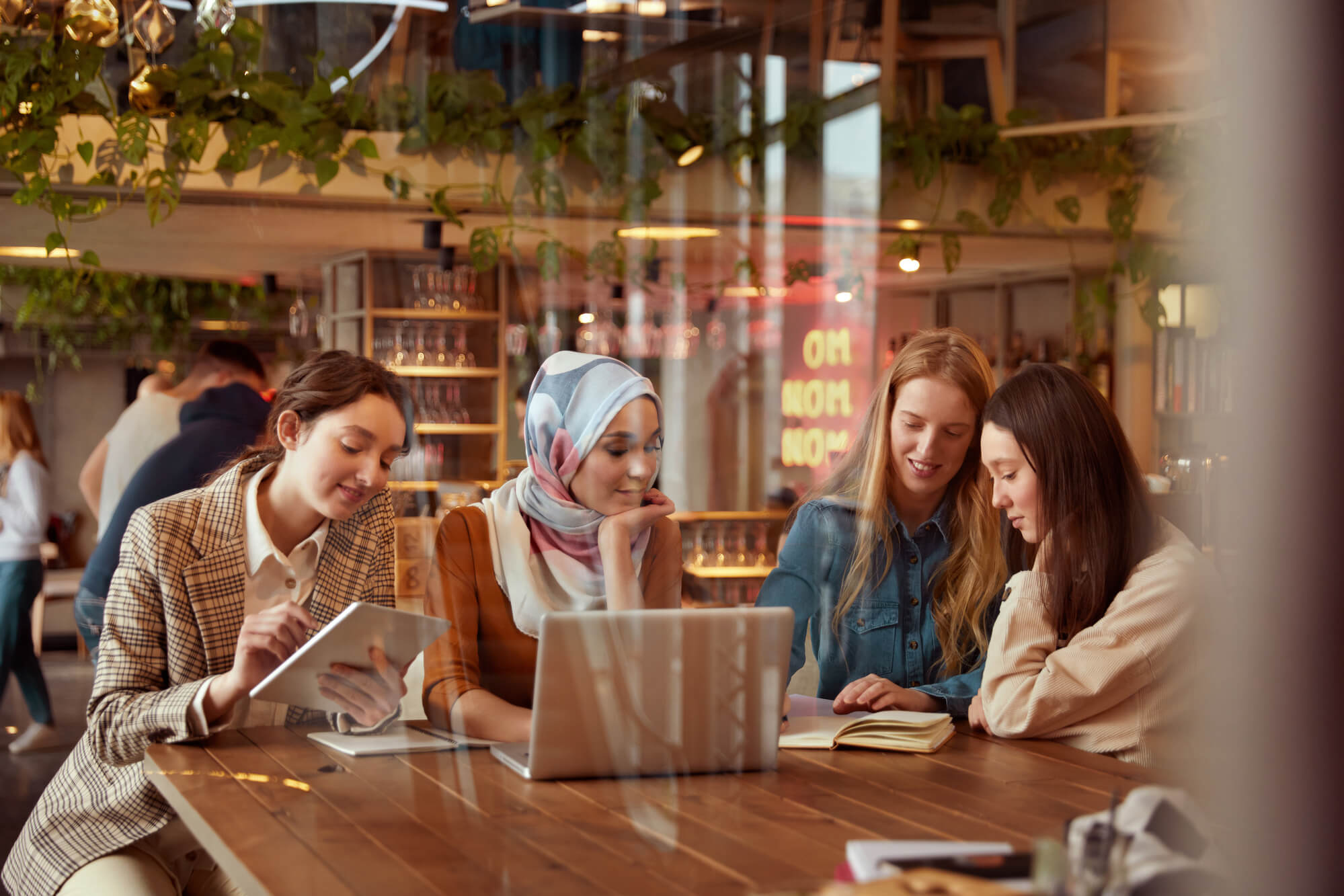 group of female friends at coffee shop digital marketing 
