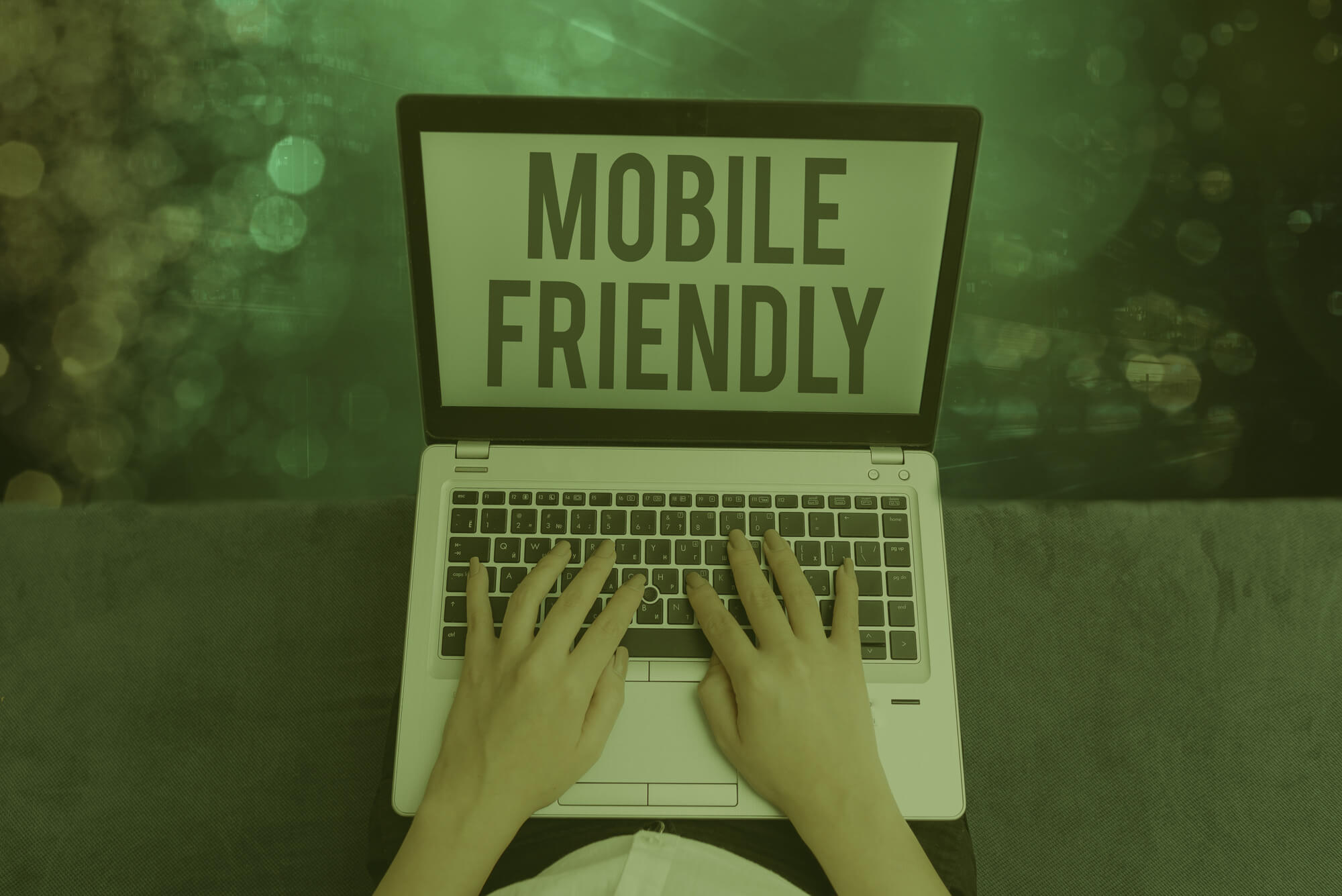 miami seo specialist using laptop with word mobile friendly on screen