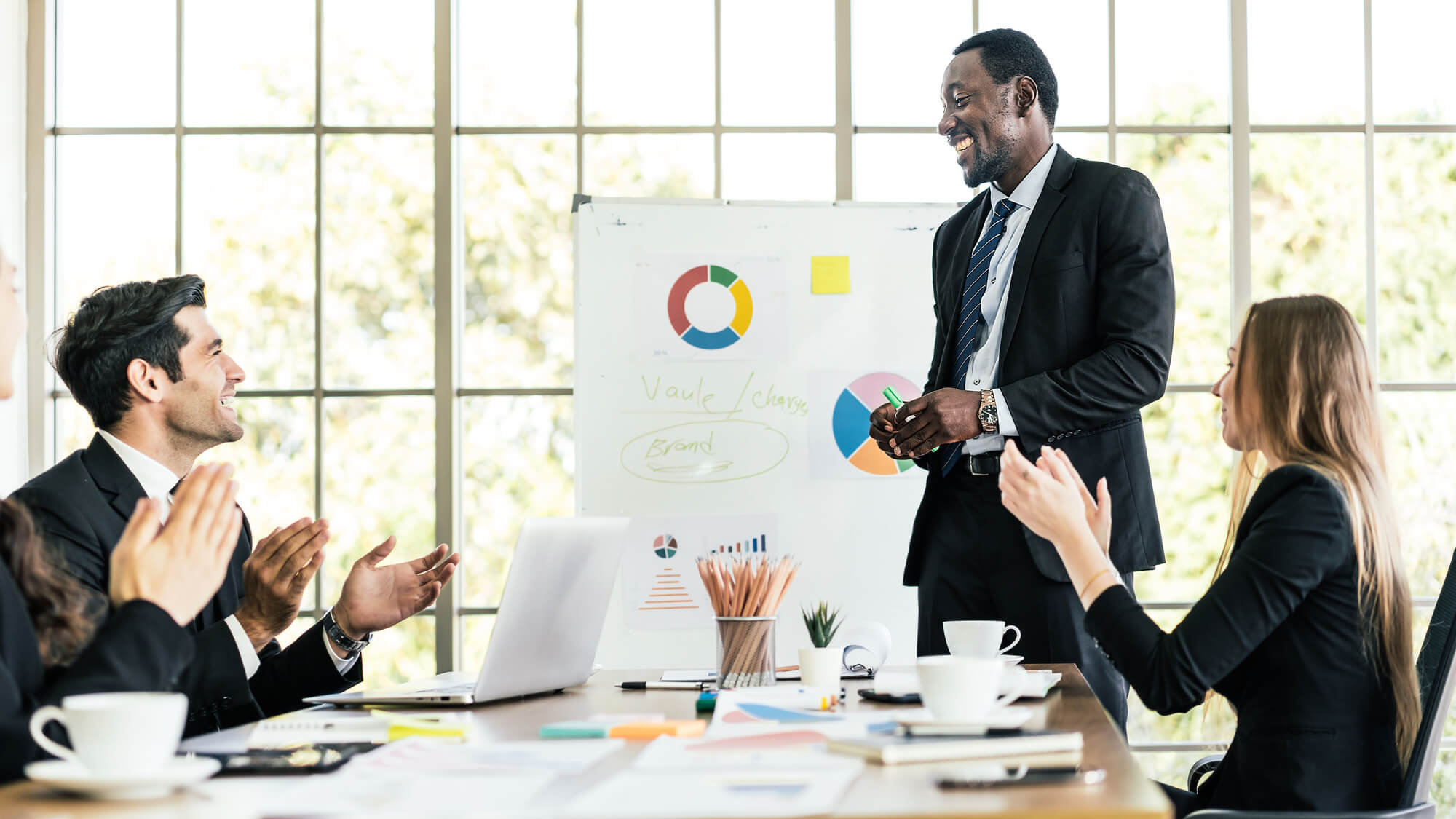 business leader and team members amused as they exchange ideas