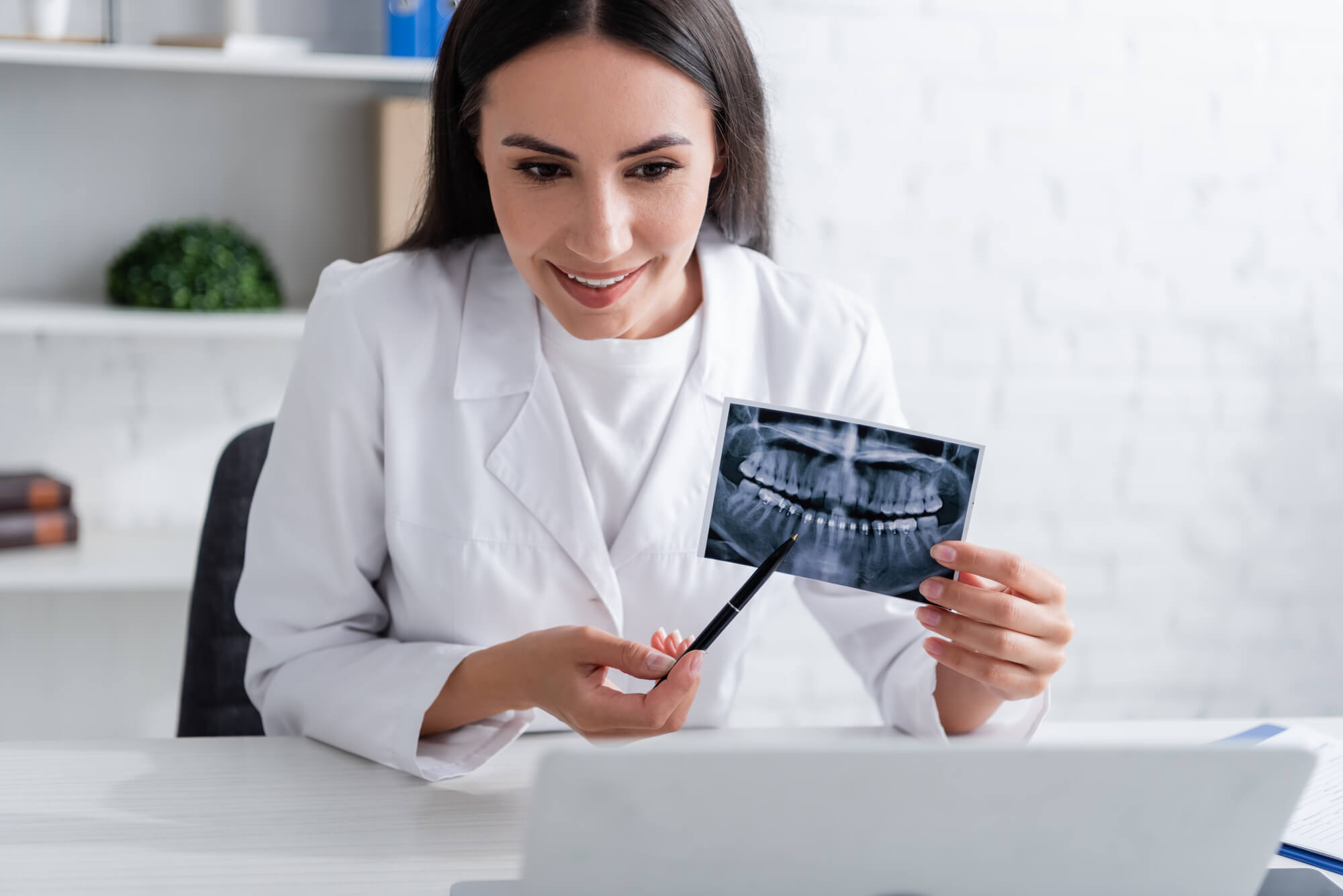 dentist showing dental xray on laptop