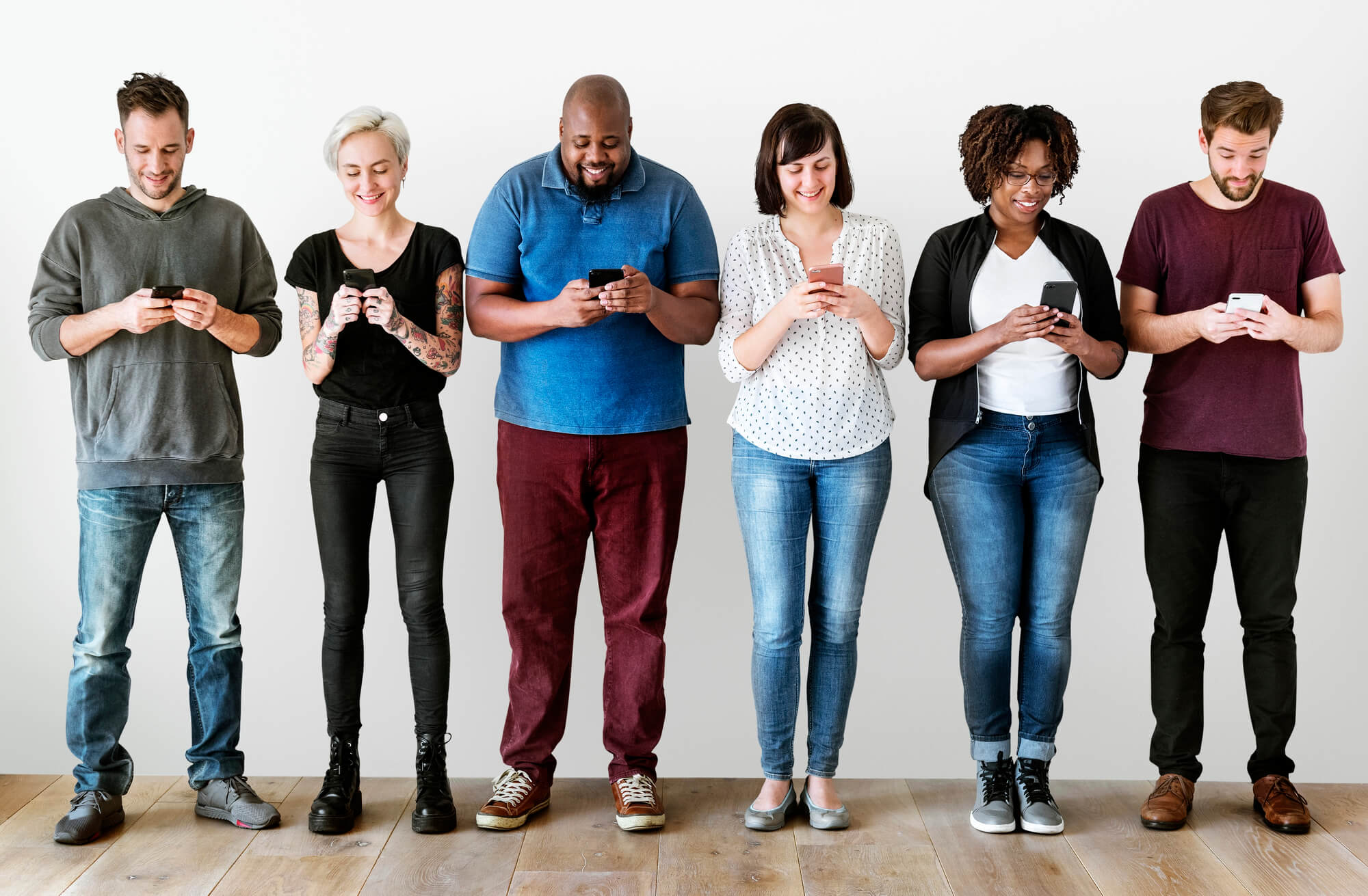 group of enthusiastic adults engaging with their phones