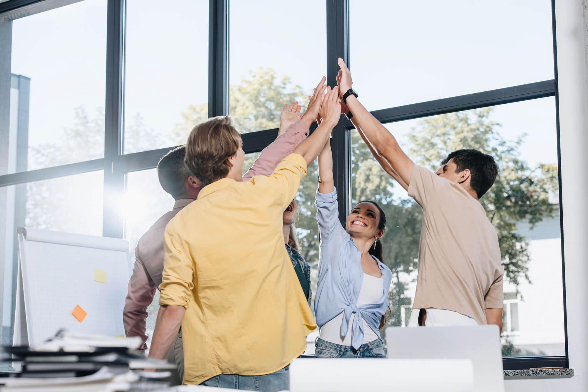 marketing team high fiving each other after a win