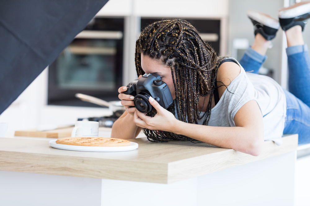 female photographer taking a photo of a meal digital marketing