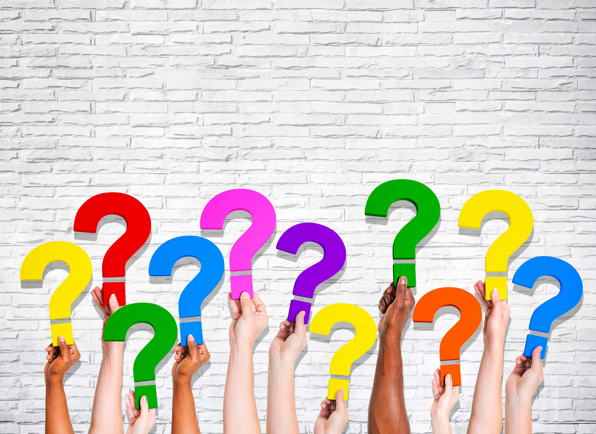 many hands holding question marks