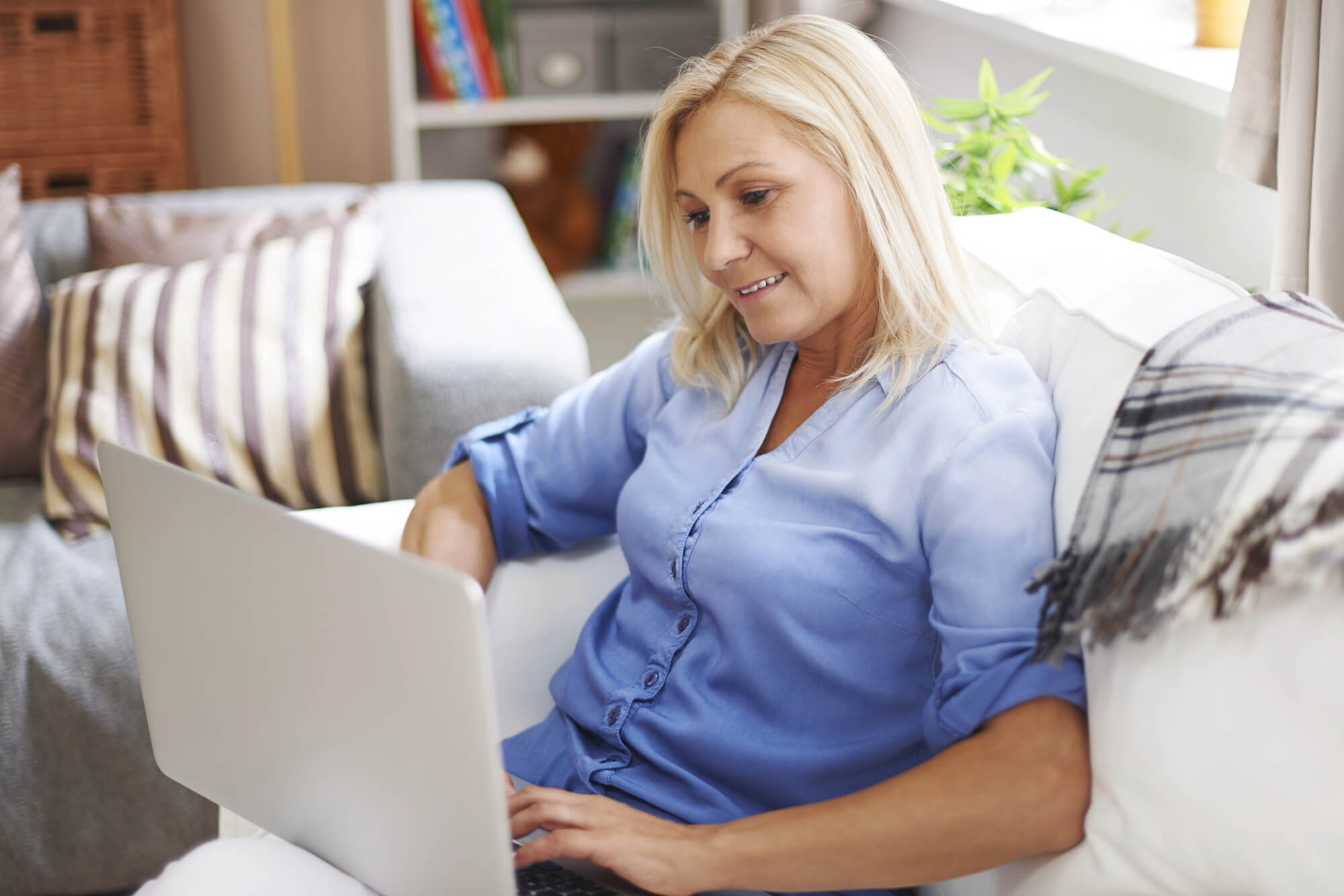 woman using laptop in living room