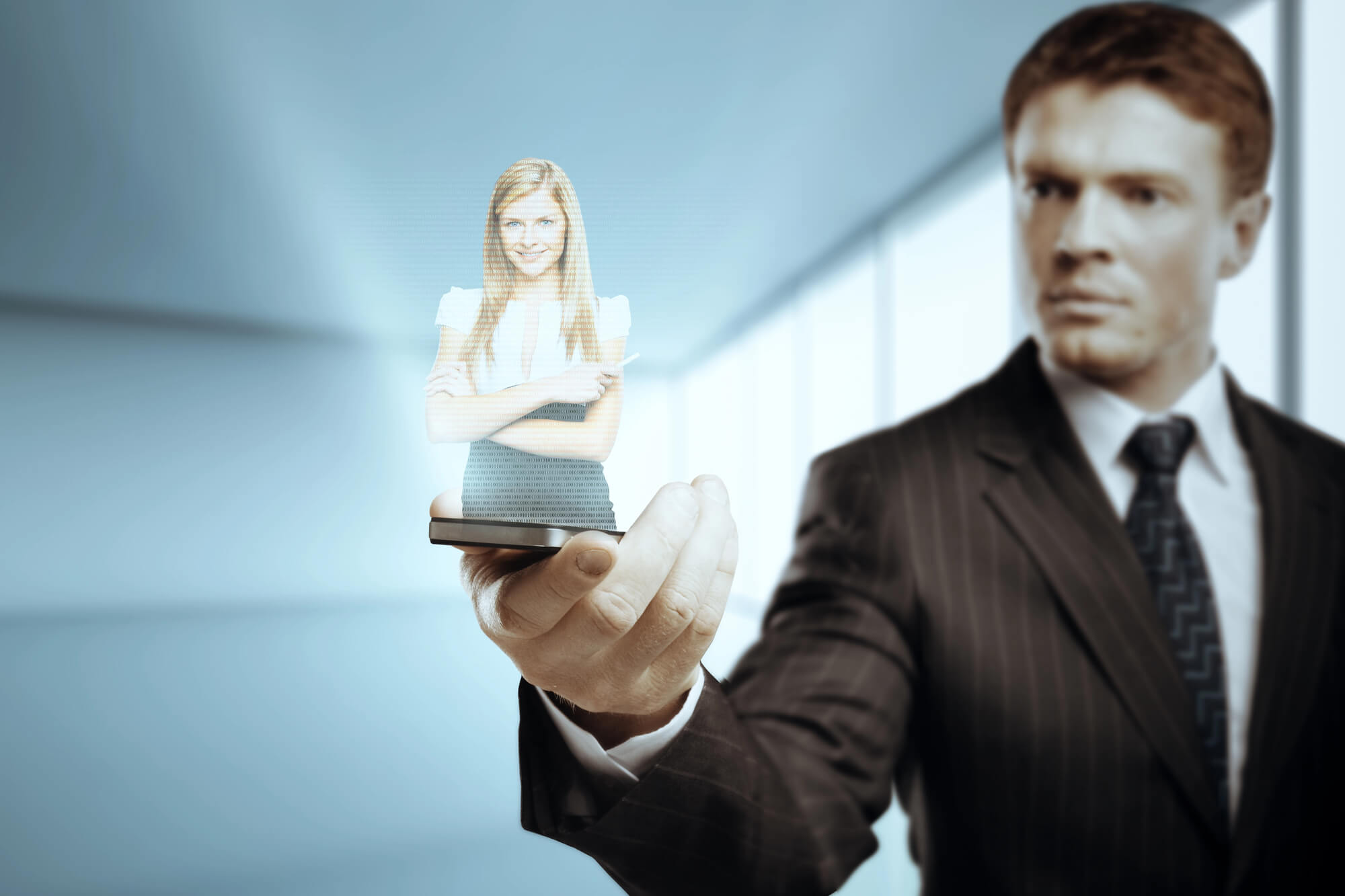 businessman holding a smartphone projecting a holographic image of a woman