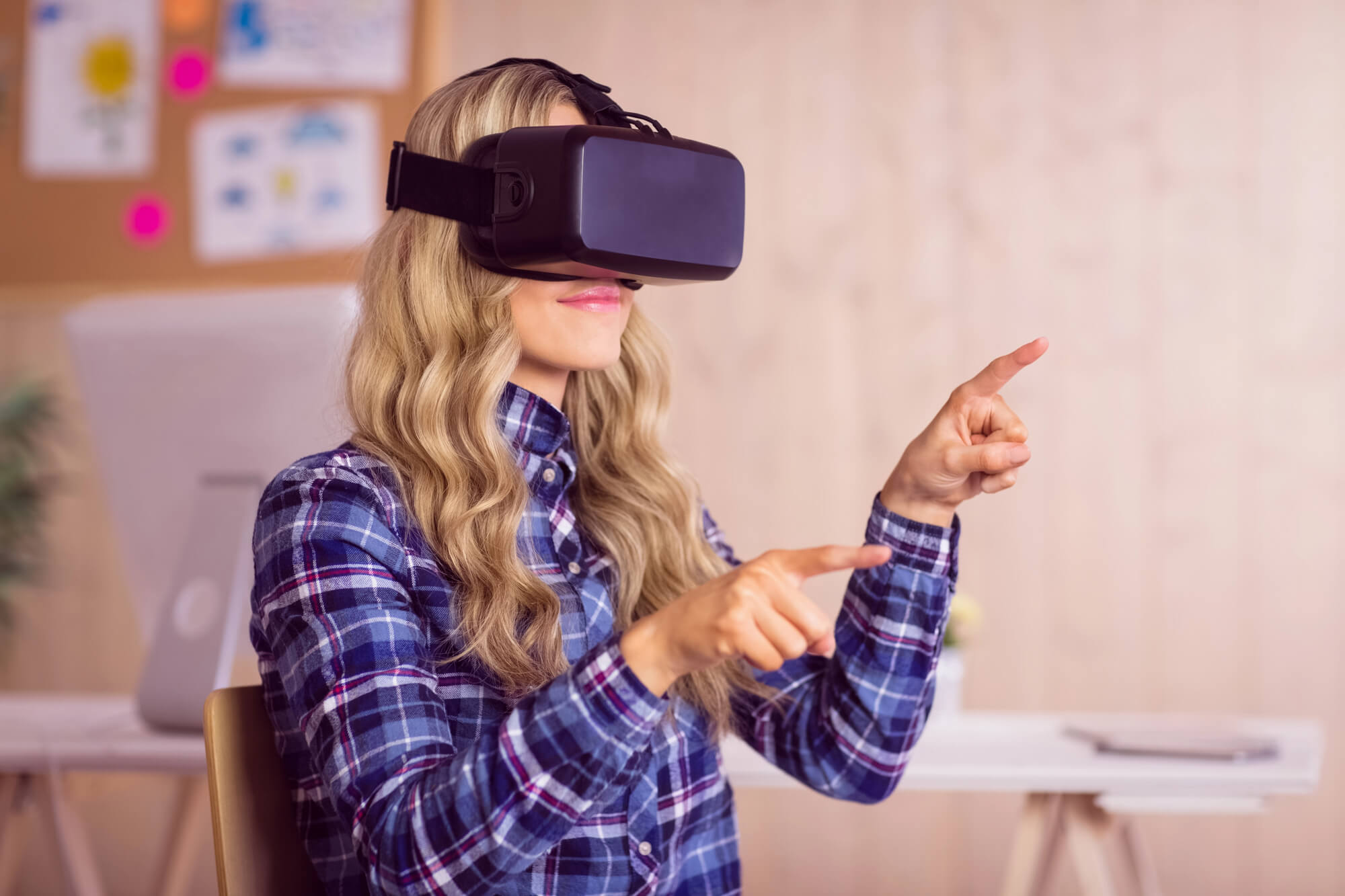 woman using a virtual reality headset and interacting with a virtual environment