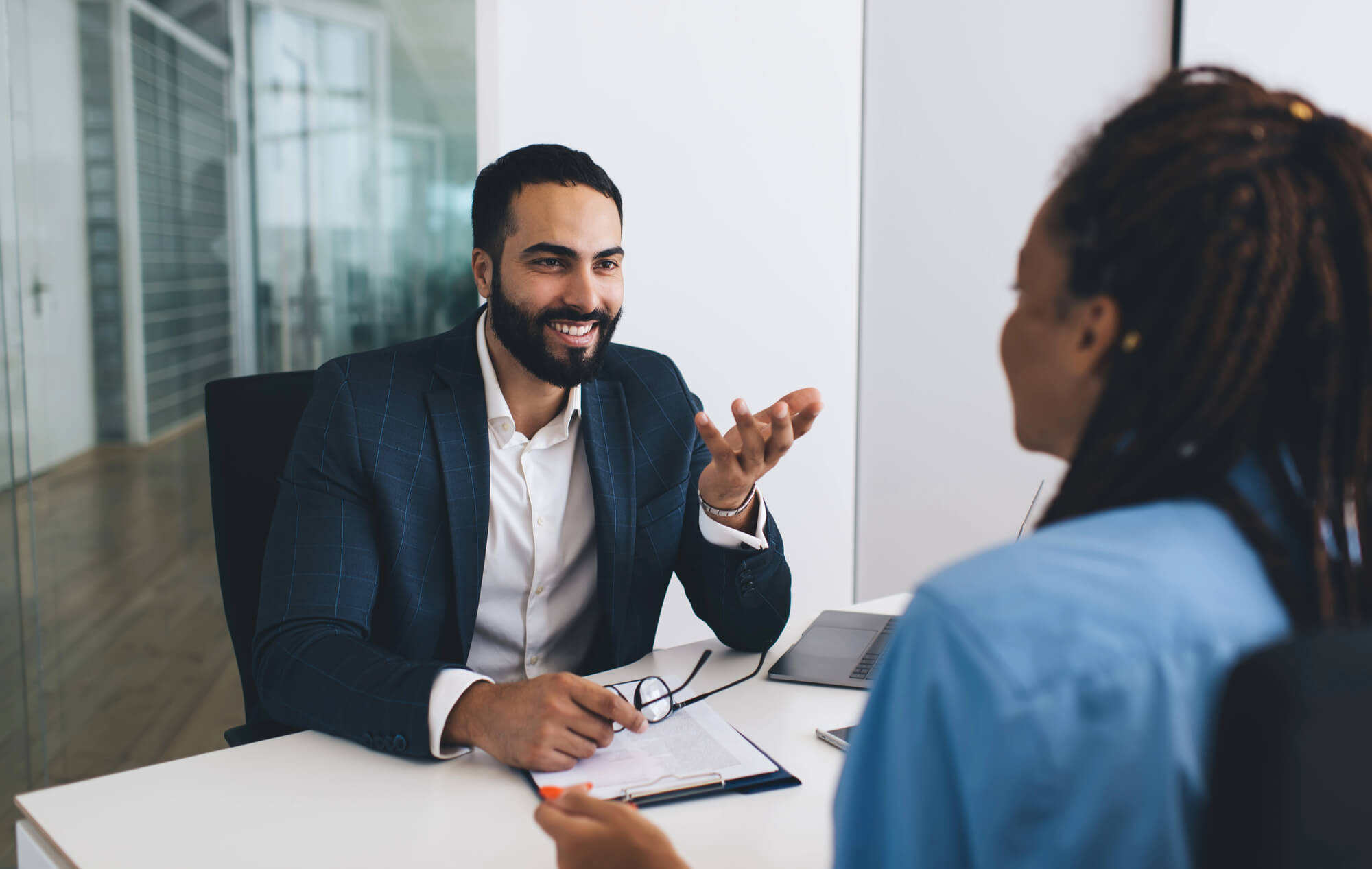 supervisor having a friendly discussion with an employee in a modern office