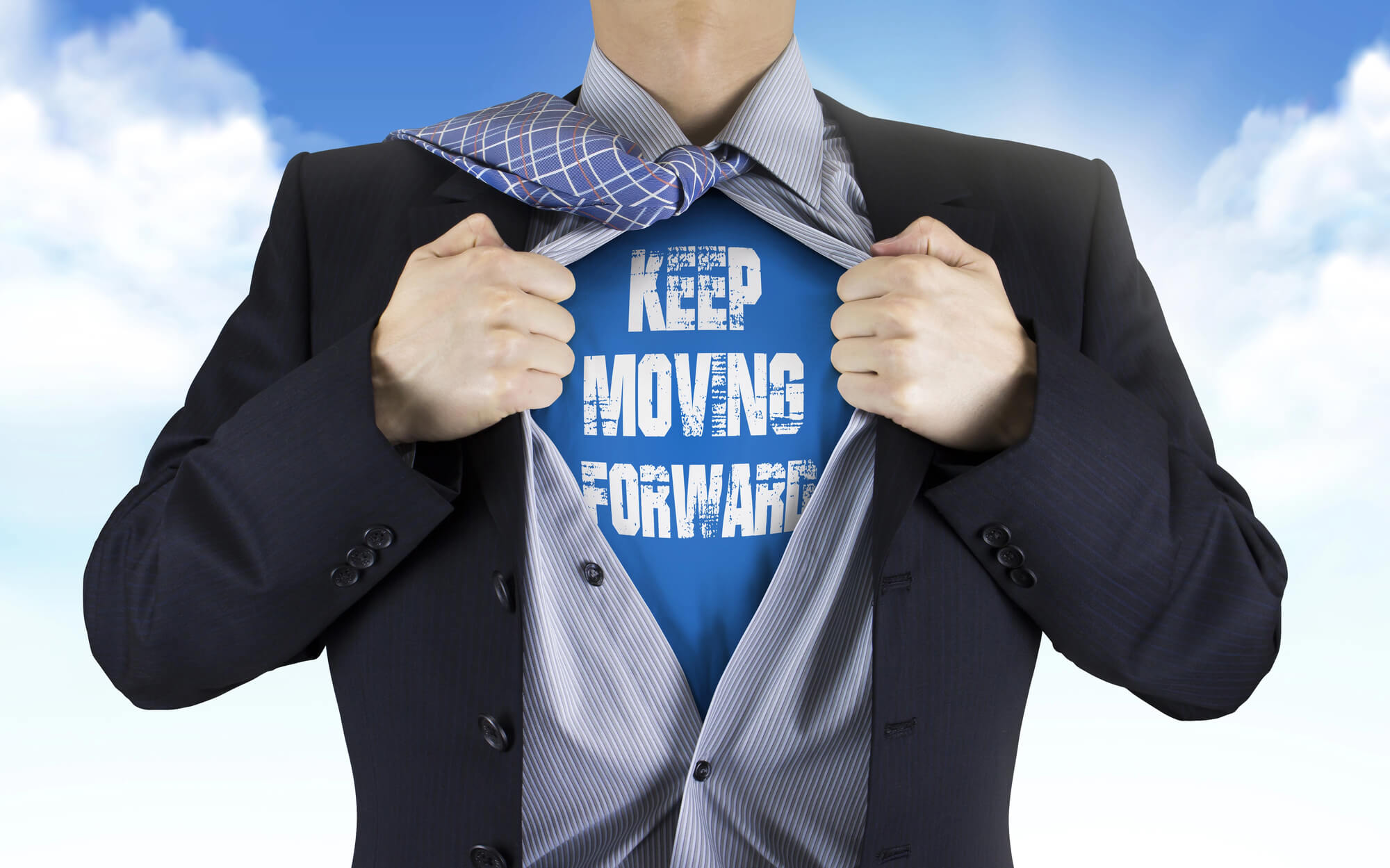 businessman in a suit pulls open his shirt to reveal the message "Keep Moving Forward" symbolizing resilience and motivation