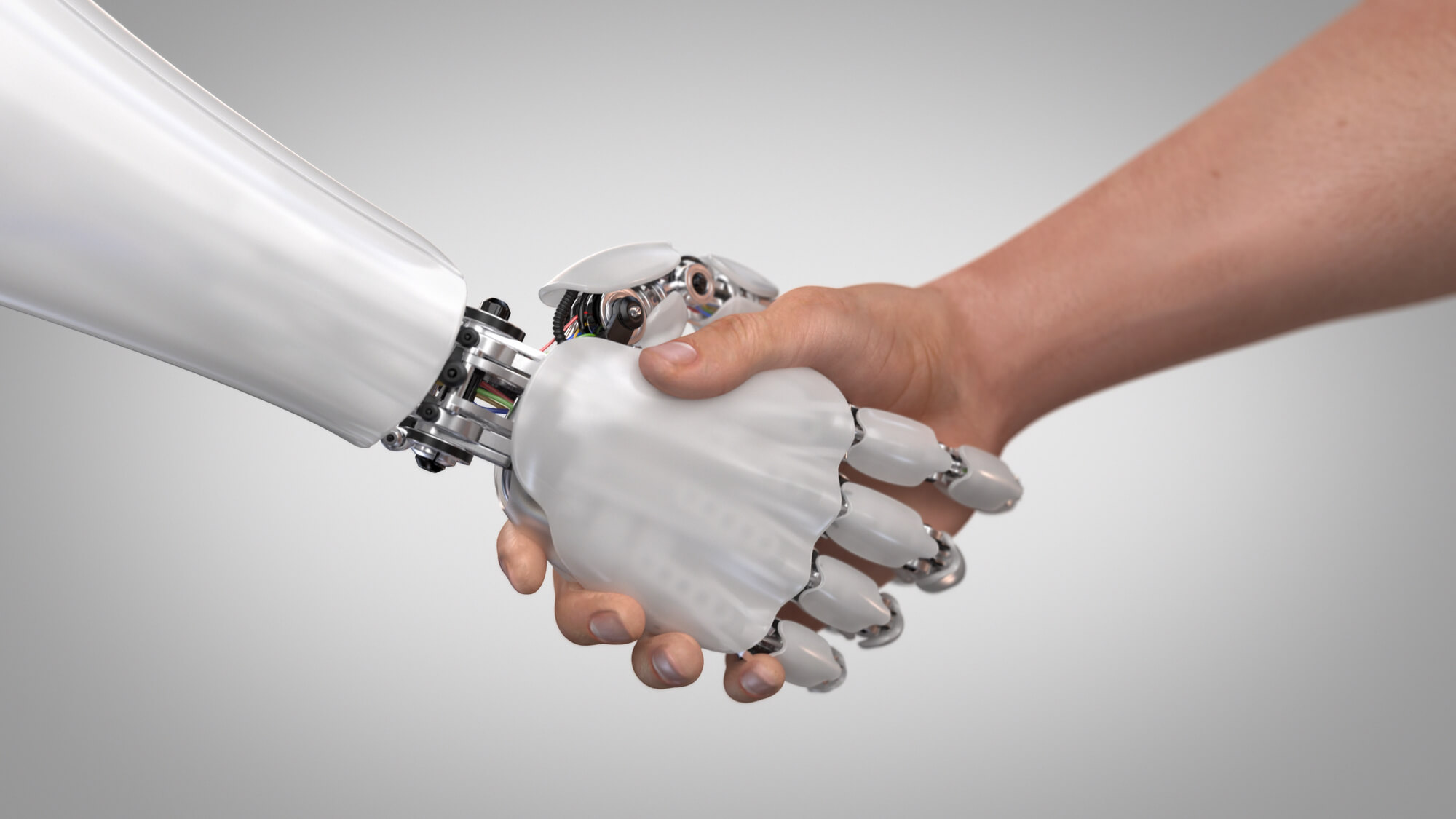robot and human shaking hands in collaboration
