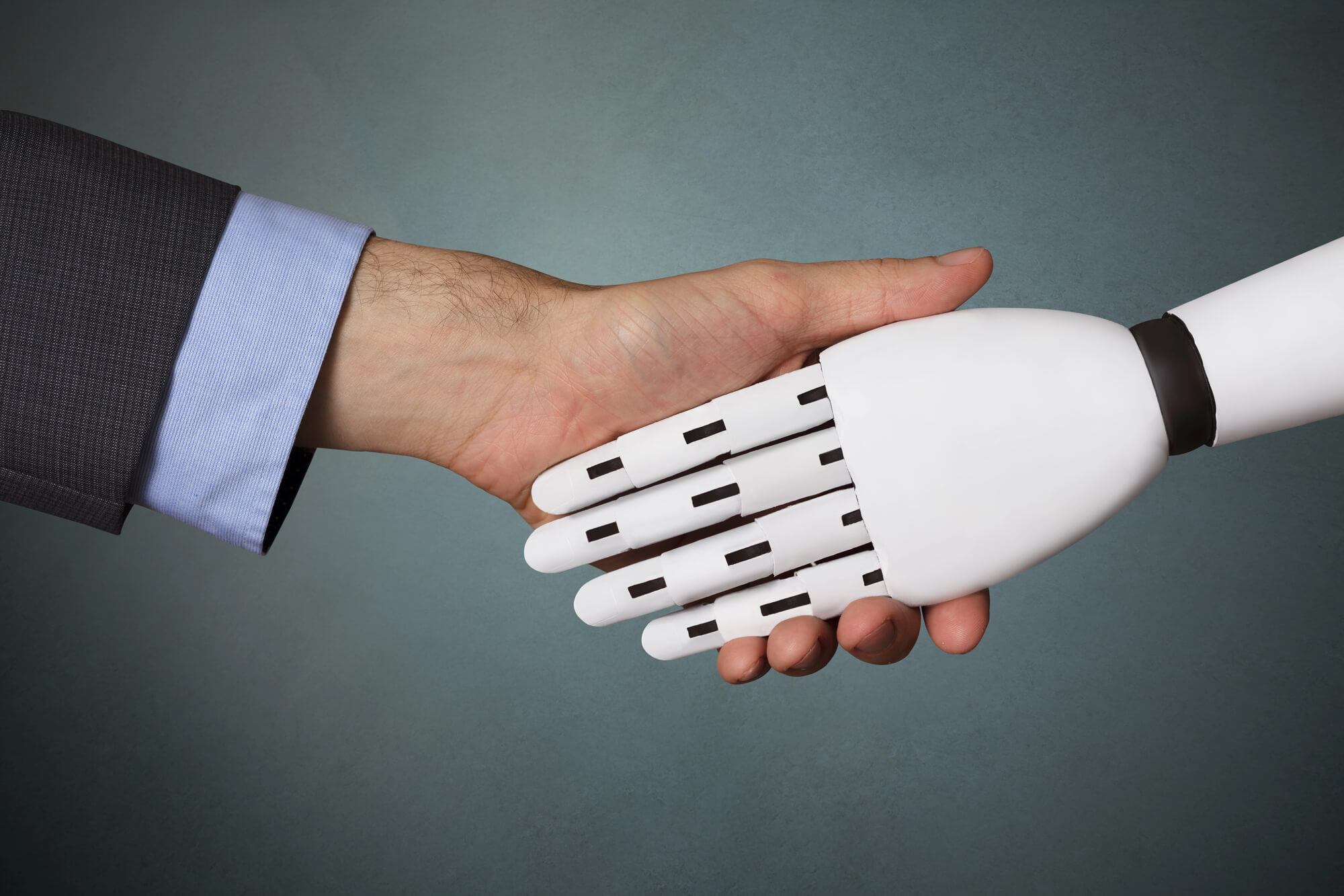 business owner and AI bot shaking hands