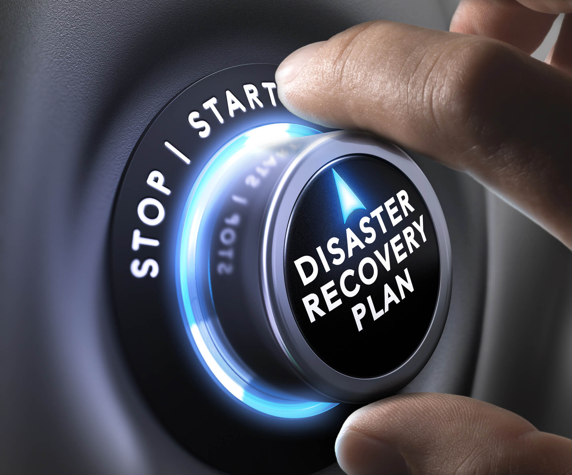 Hand turning a dial labeled "Disaster Recovery Plan," symbolizing preparation and crisis management