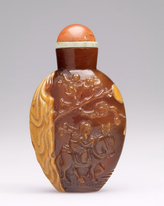 Amber with carved depiction of Huang Chenyen on his donkey
