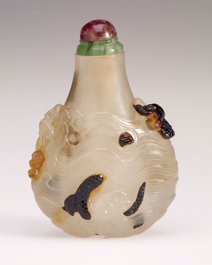 Chalcedony with carved dragon among waves