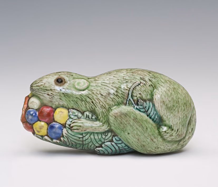 Porcelain molded in the form of a squirrel on a grapevine