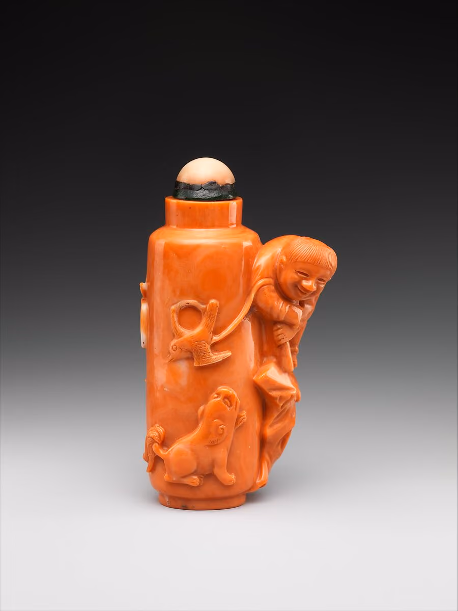 Coral carved with boy flying a bird