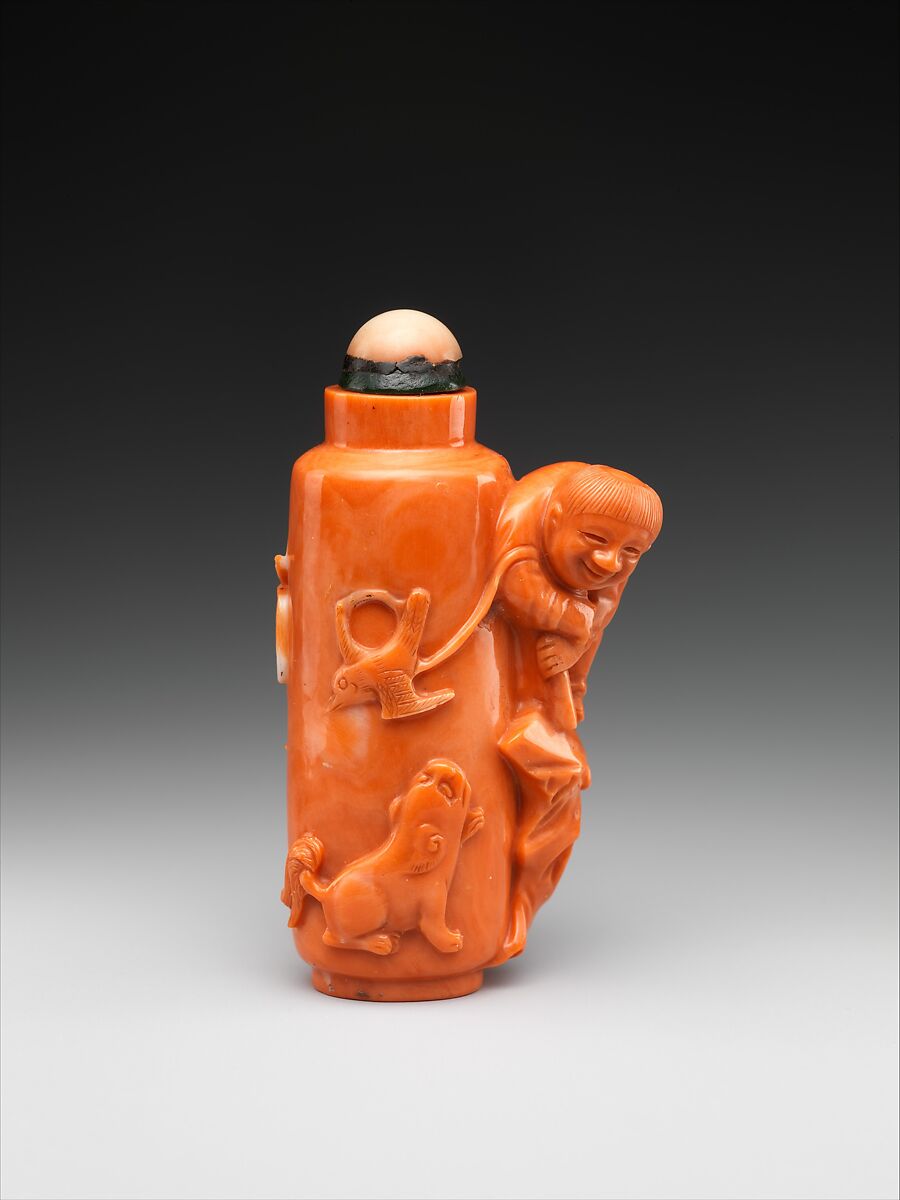 Coral carved with boy flying a bird