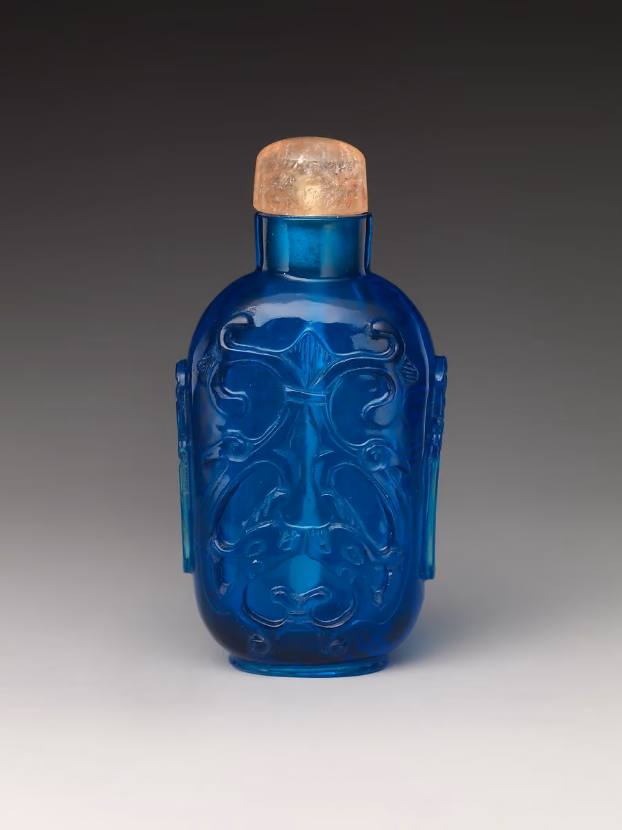 Carved blue glass with antiquarian design