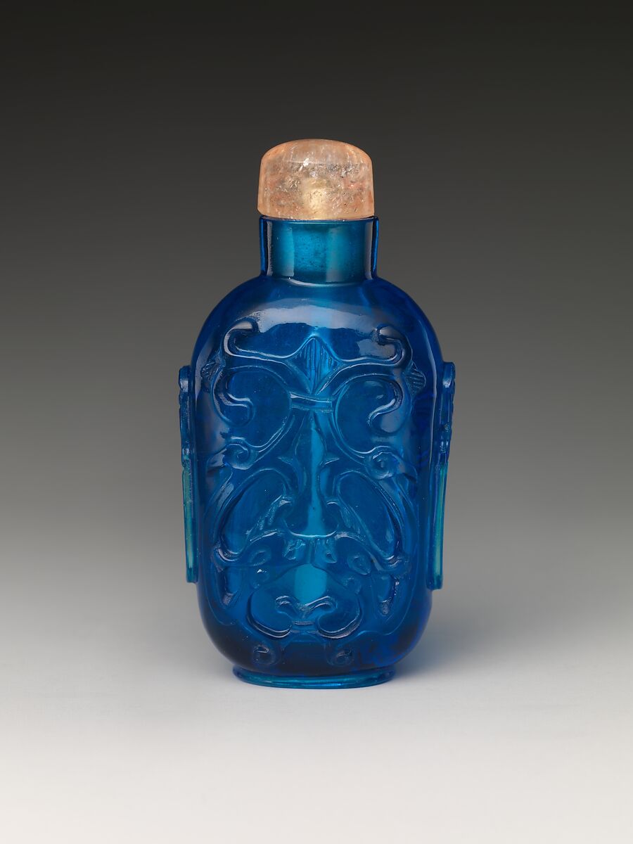 Carved blue glass with antiquarian design