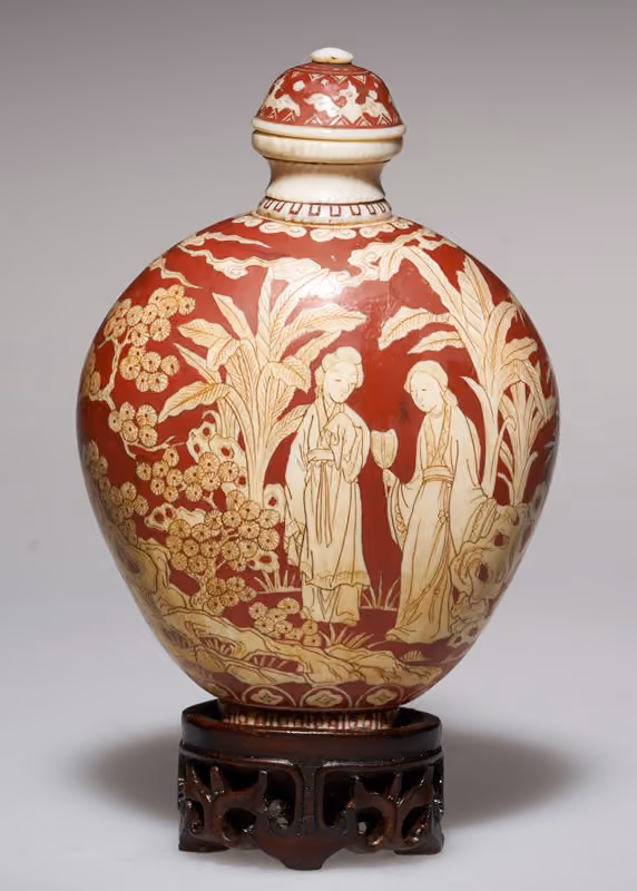 Ivory carved with two women in a garden