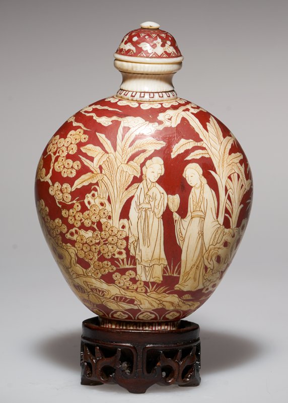 Ivory carved with two women in a garden