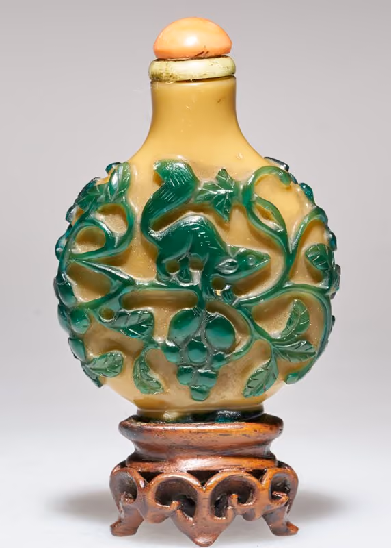 Green overlay glass with squirrel among fruiting vines