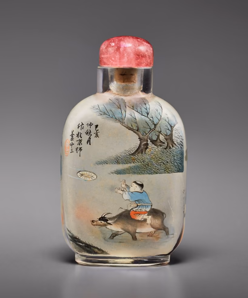Inside-painted glass with boy on buffalo and goldfish