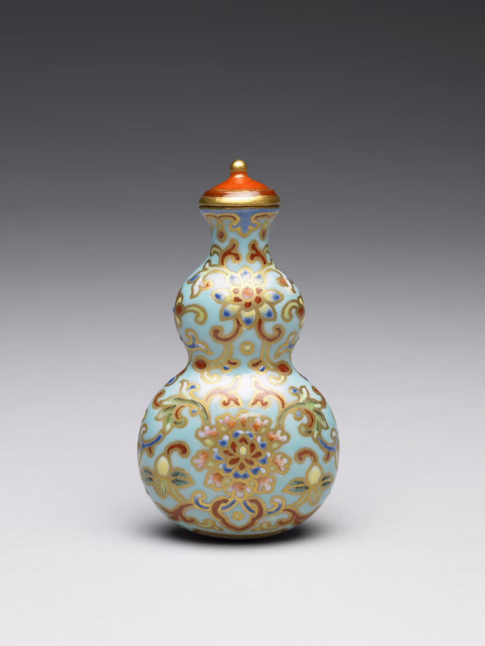 Gourd-shaped Snuff Bottle with Winding Branch-and-Blossom Decoration in Famille-Rose on a Lake-Green Ground