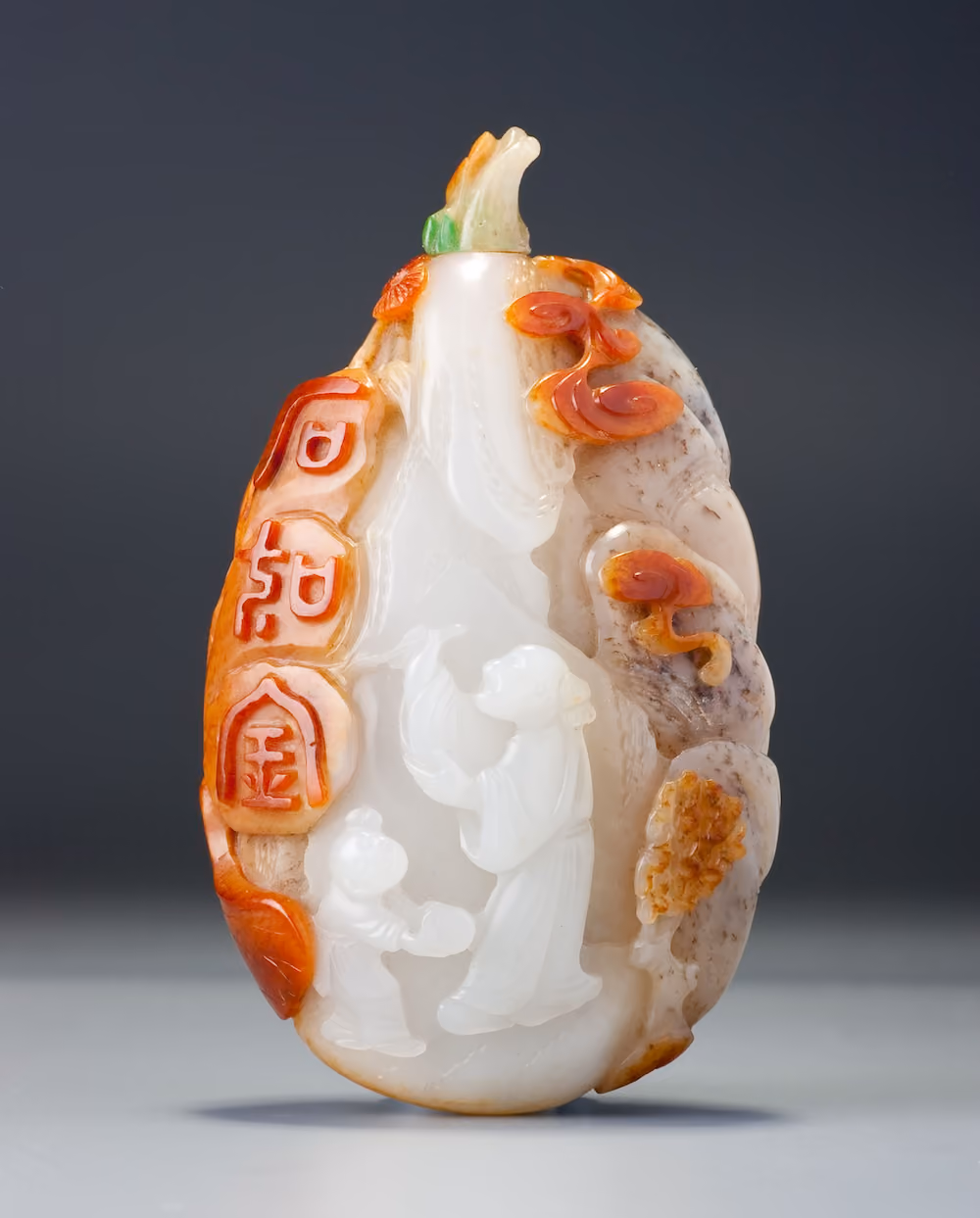 Nephrite pebble carved with scholars in a rocky landscape