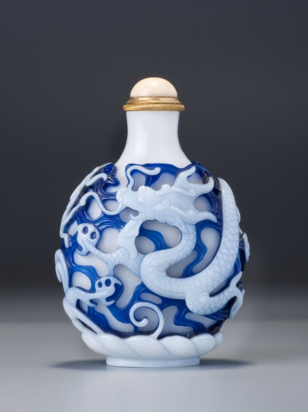 Double overlay glass with dragons among clouds and waves