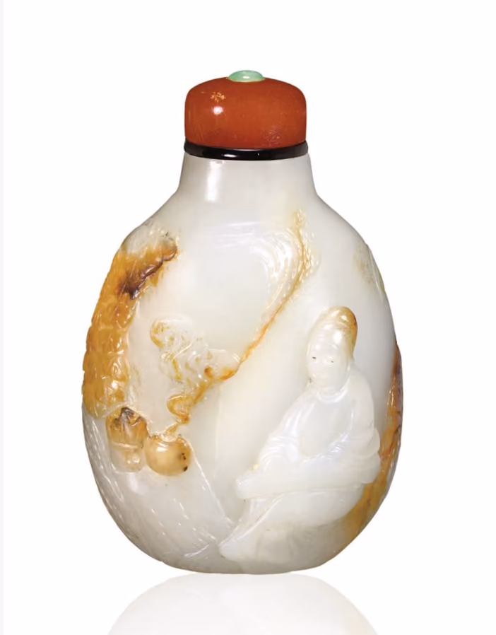 Jade pebble with scholar playing qin in a landscape