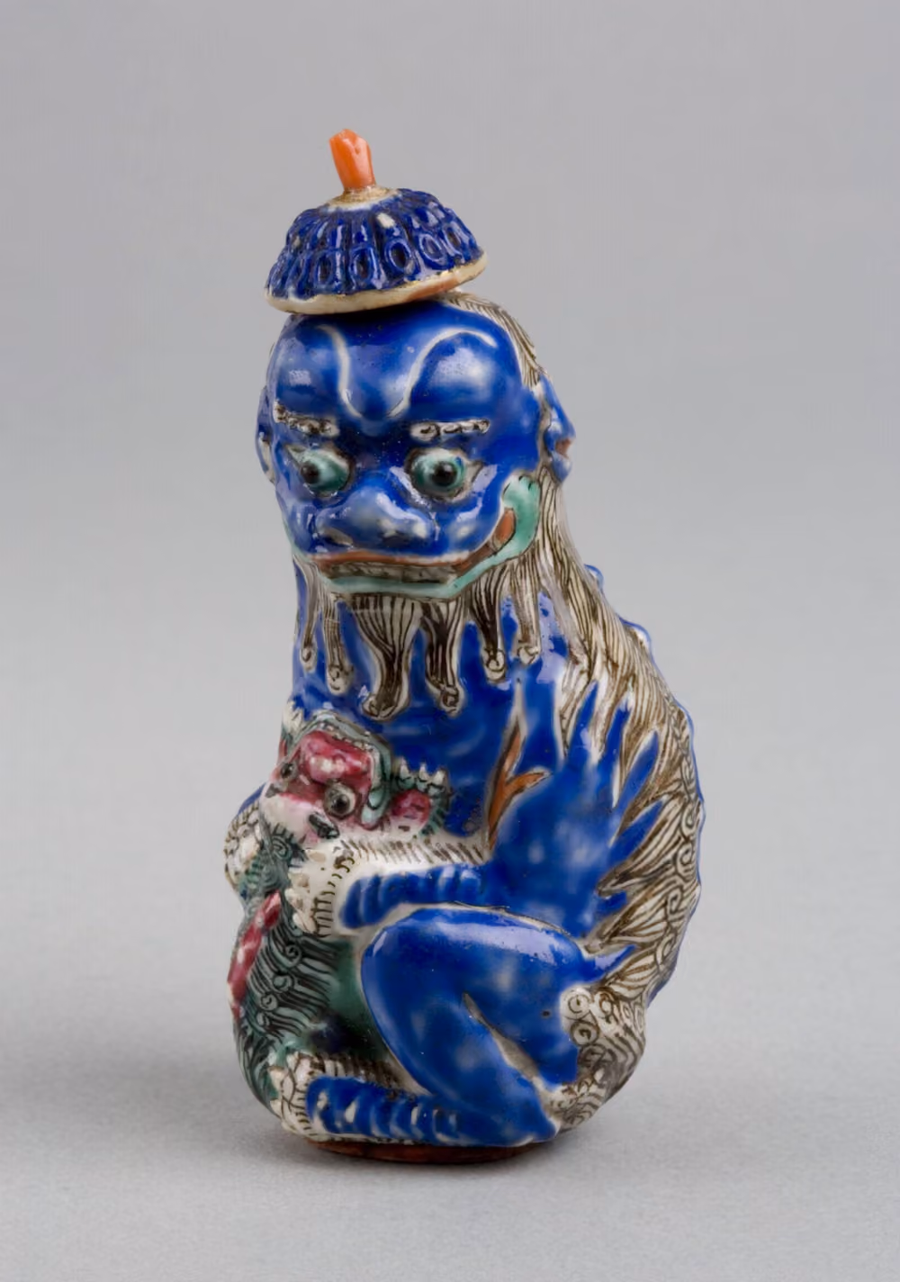 Porcelain in the form of a lioness with cub and ball