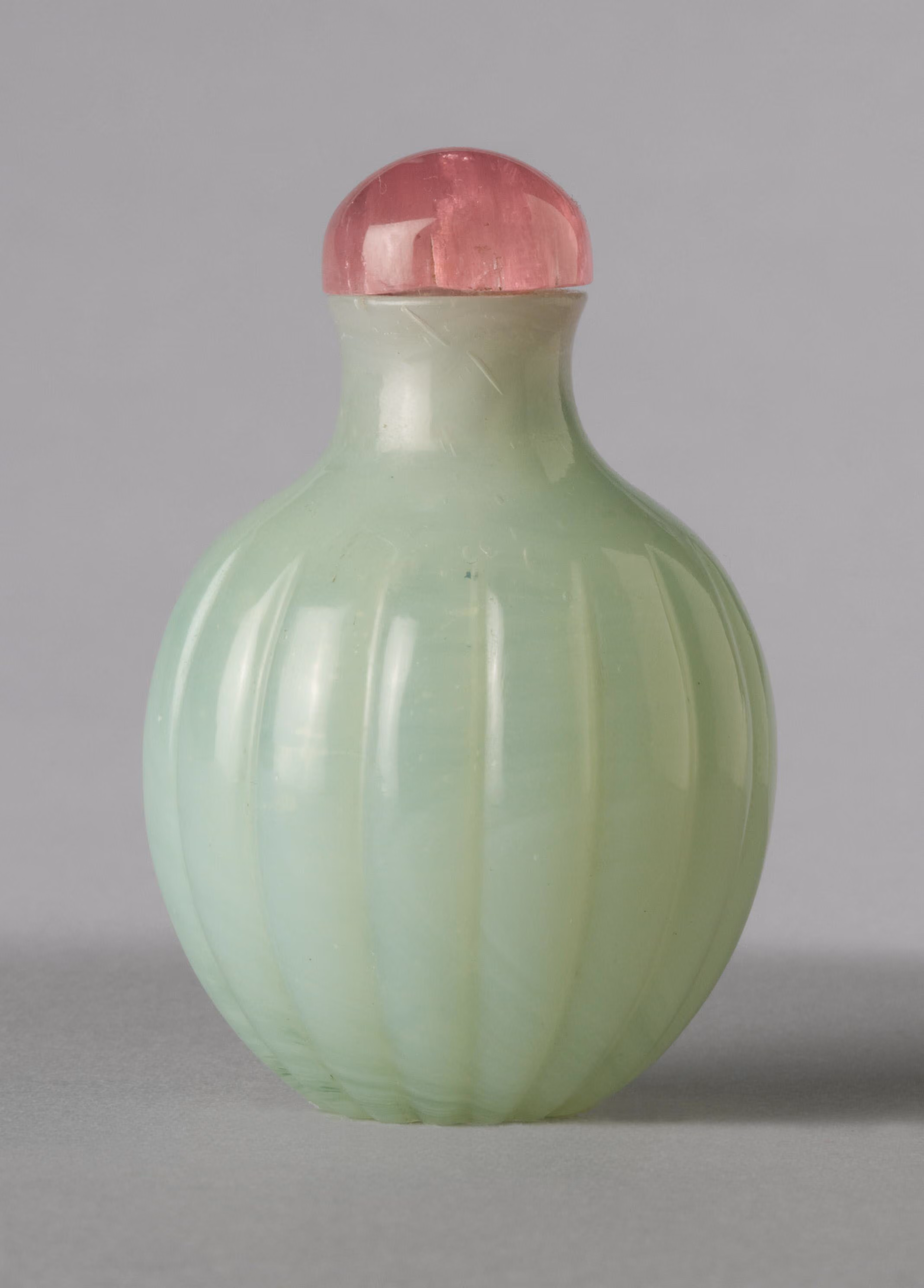 Pale green fluted glass of bulbous form
