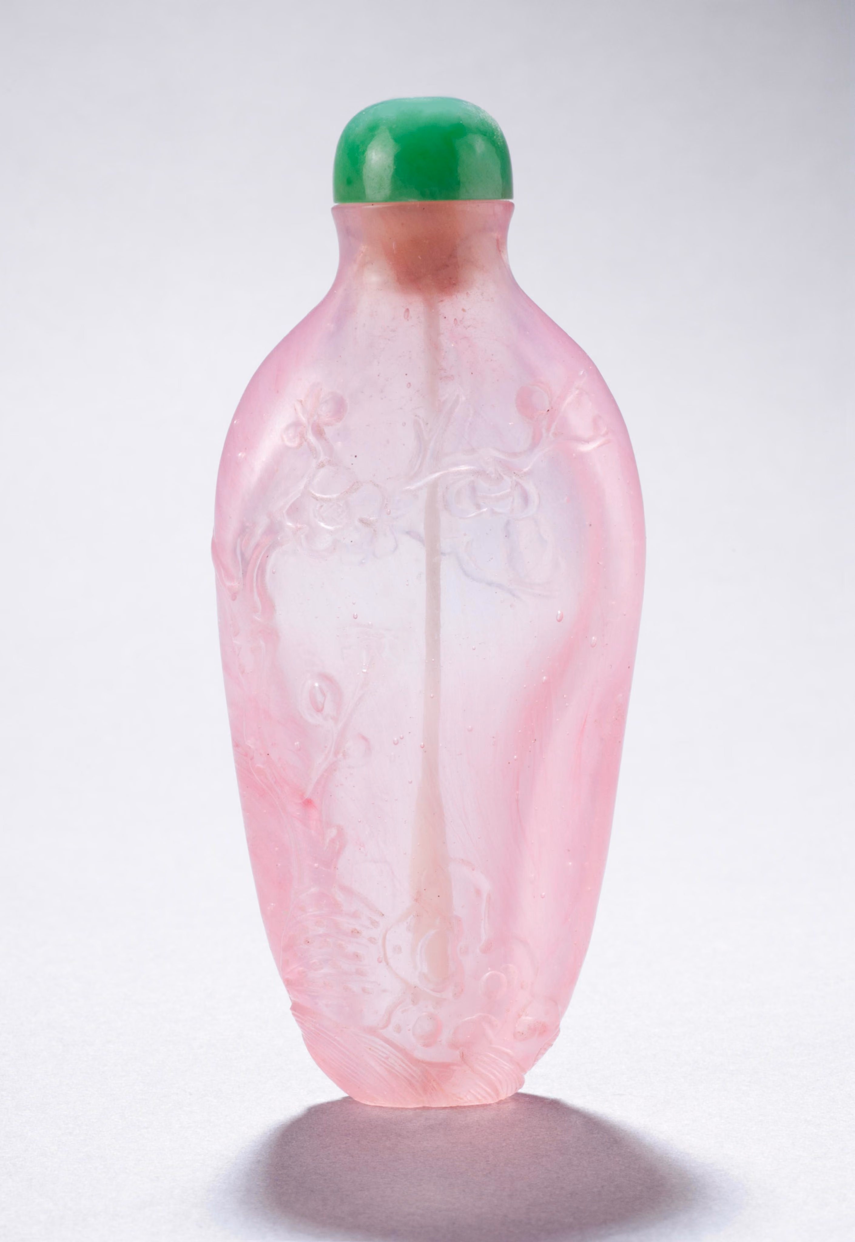 Pink glass carved with prunus