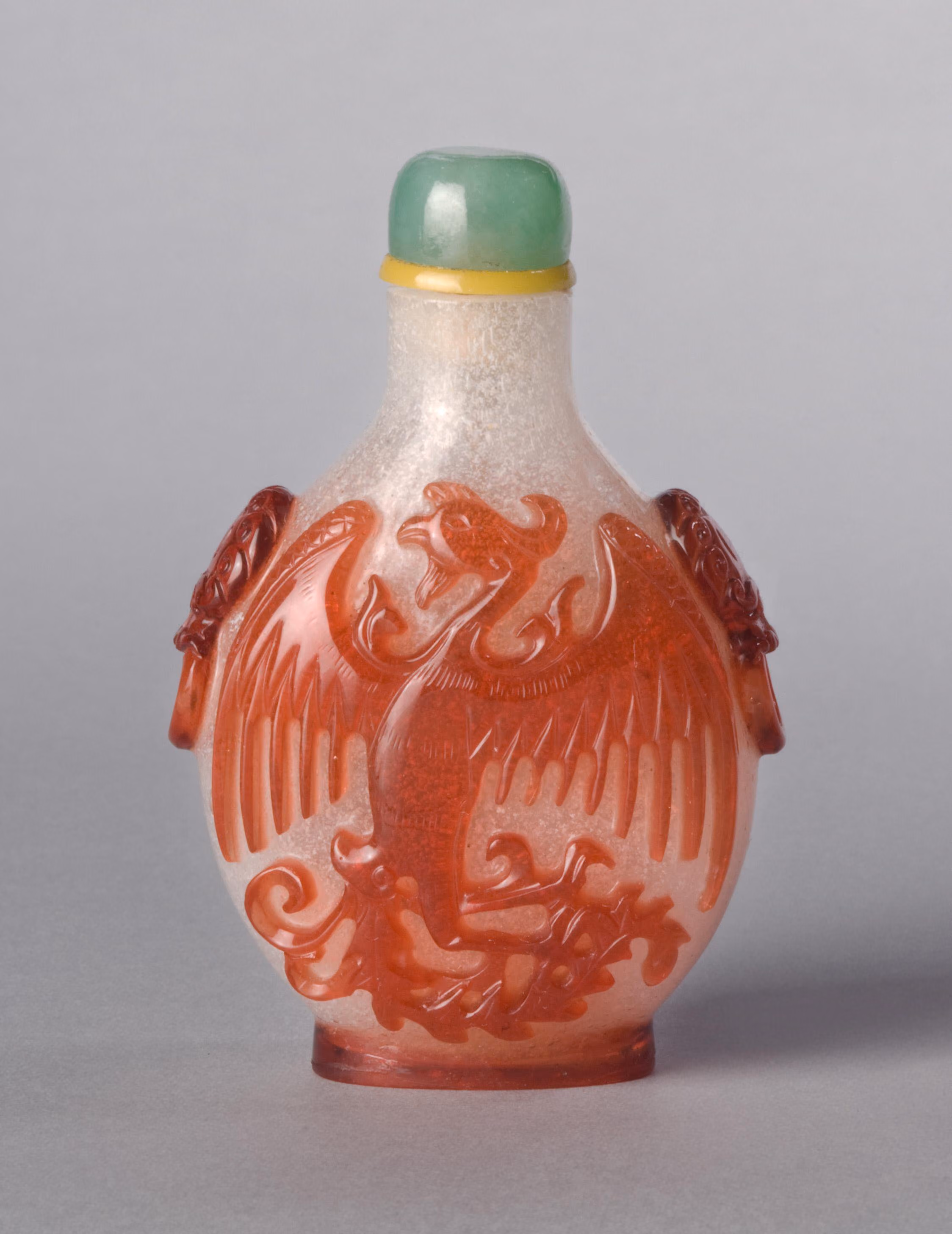Red overlay on bubble-suffused glass with dragon, phoenix, and taotie masks