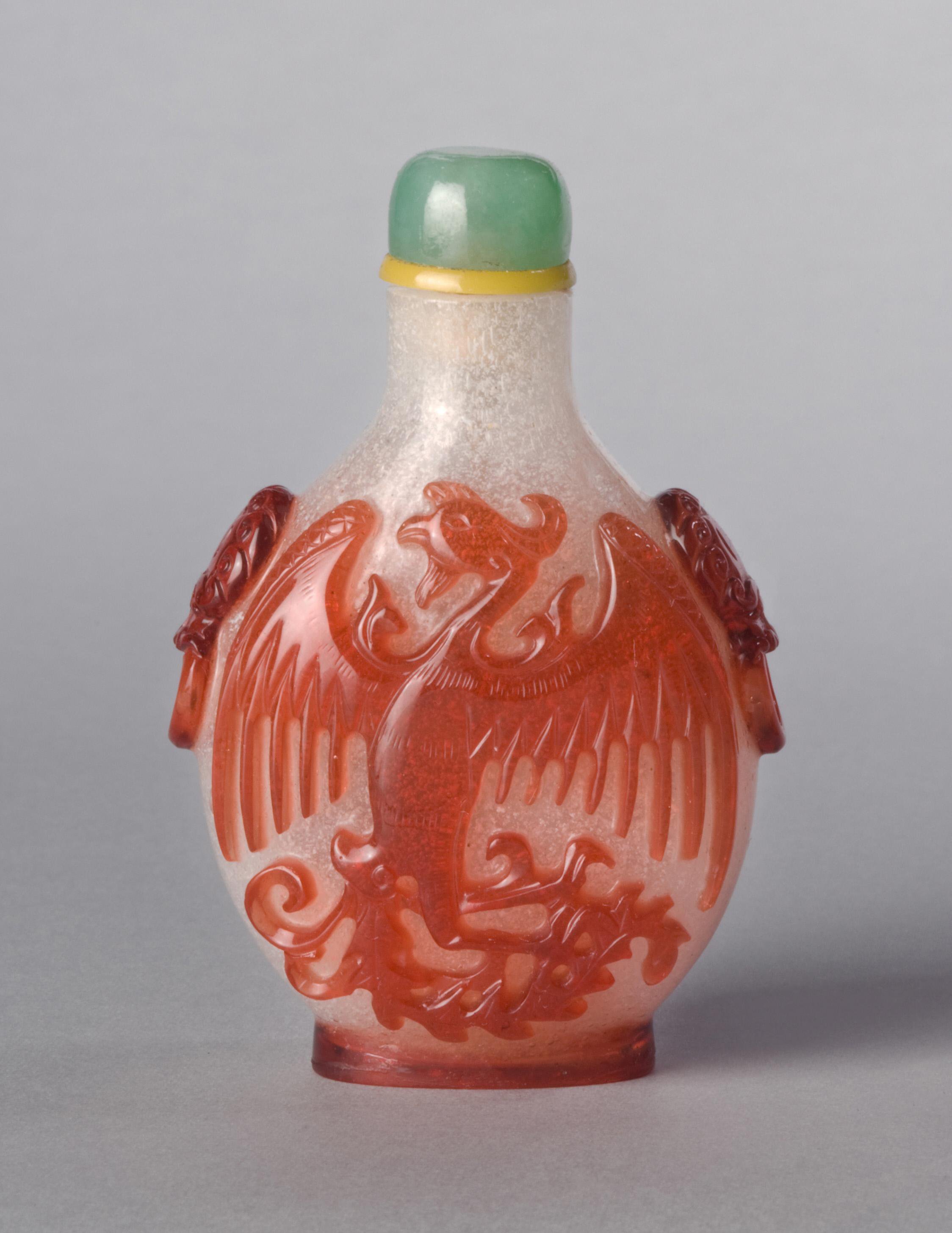 Red overlay on bubble-suffused glass with dragon, phoenix, and taotie masks