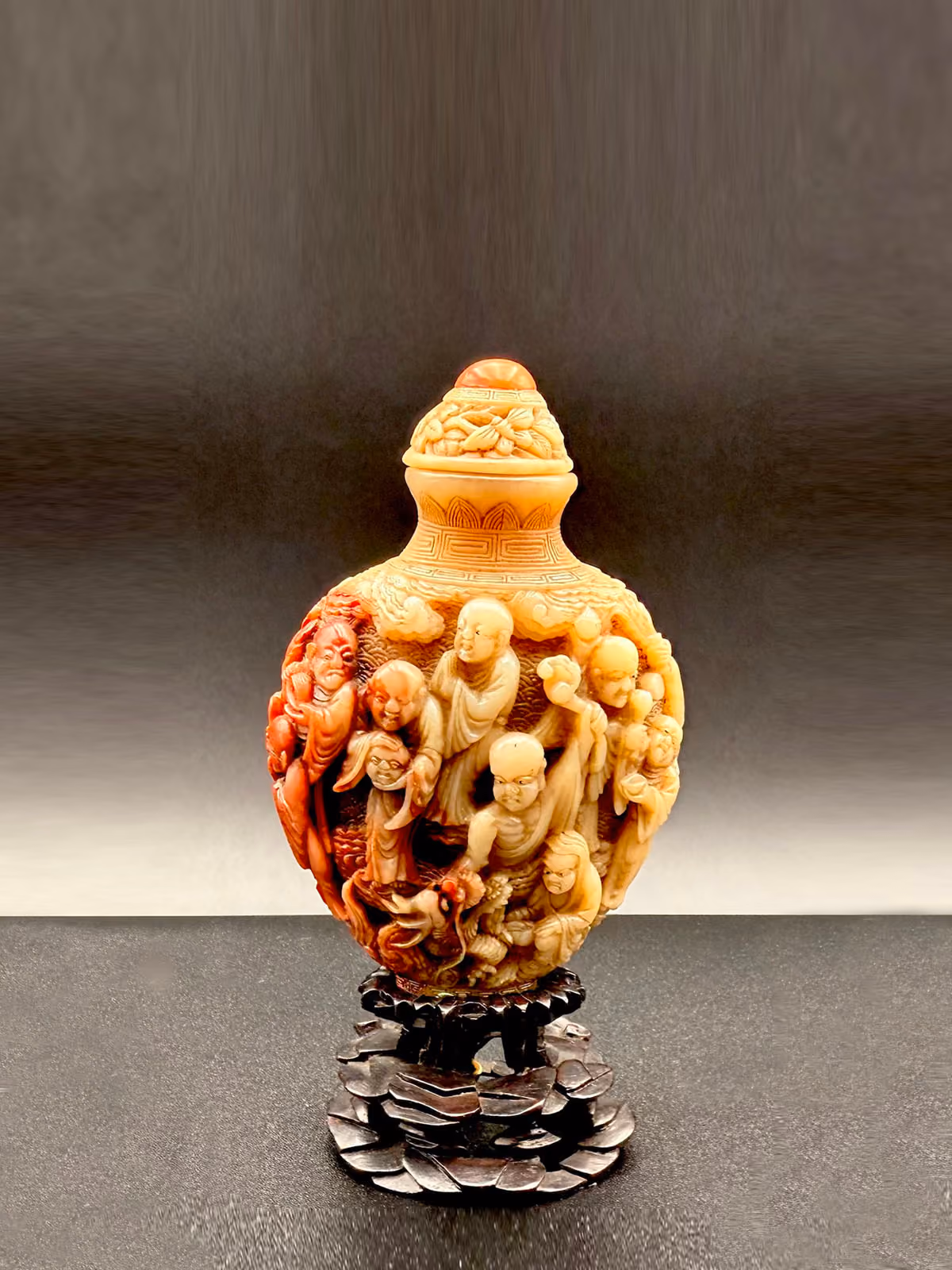 Soapstone of spade form with eighteen Luohans and dragon