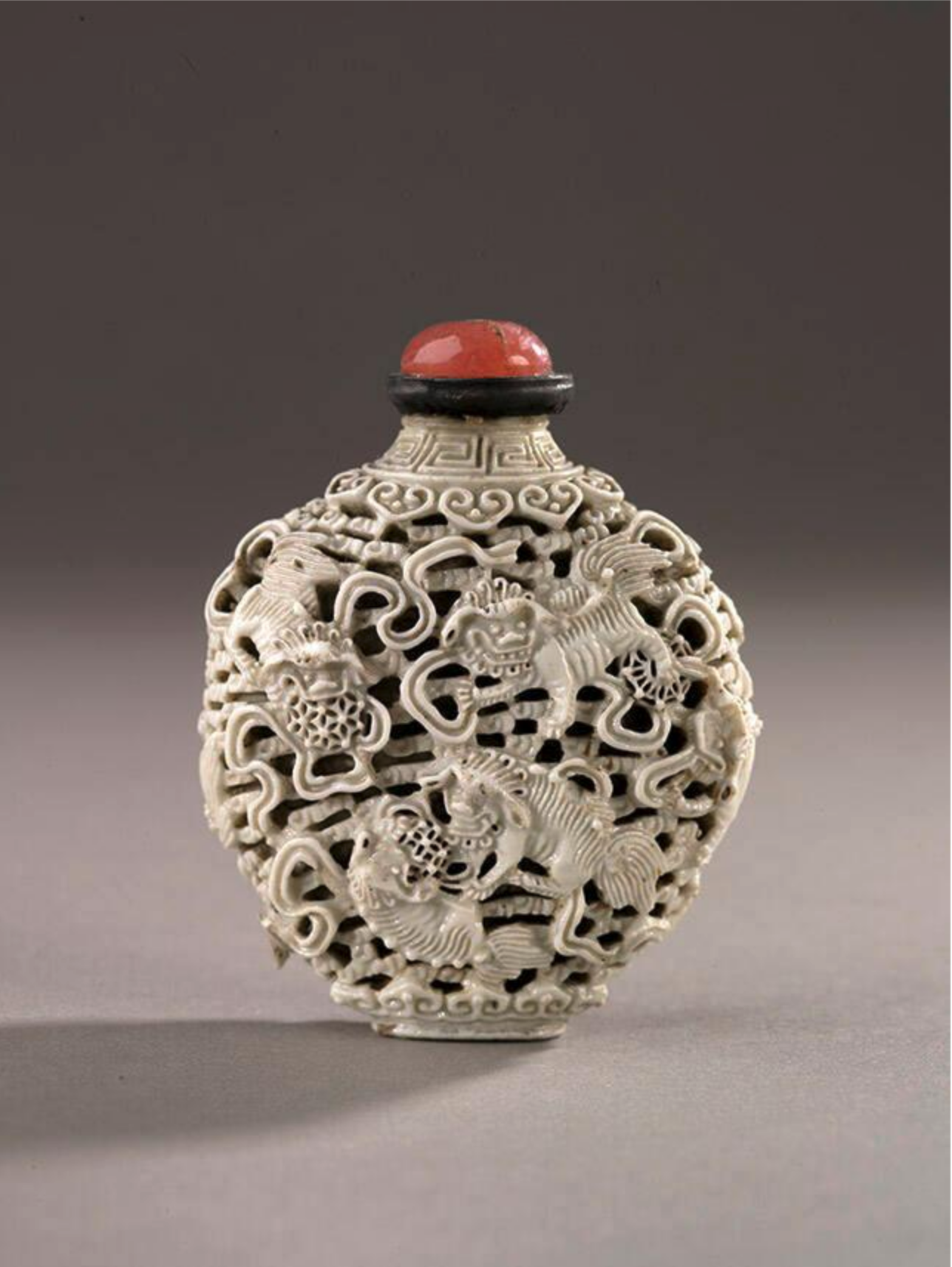 Reticulated white porcelain with Buddhist lions and brocade balls