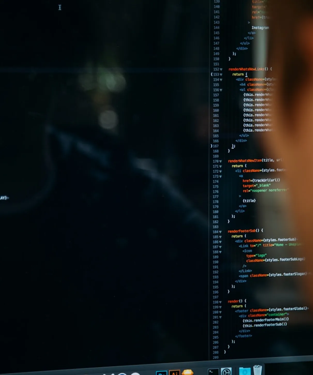 Person analyzing stock charts on a laptop at a table with another computer nearby.