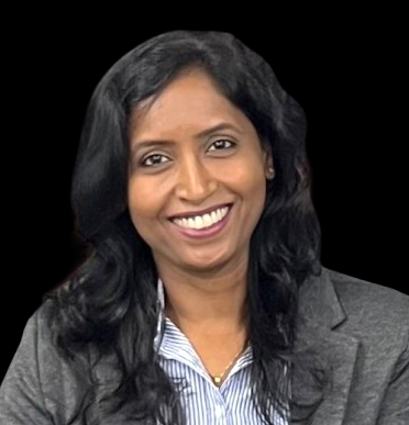 Smiling woman with long black hair wearing a gray blazer and striped shirt against a black background.
